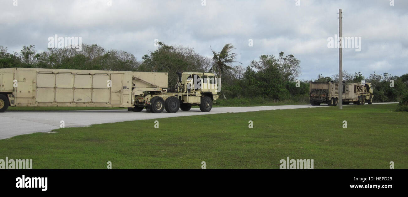 Terminal High Altitude Area Defense equipment from Battery D, 2nd Air Defense Artillery Regiment convoys back to Site Armadillo shortly after the passing of Typhoon Dolphin. The strong storms that strike Guam can be destructive, but it will never break the confidence Task Force Talon Soldiers have in their training and the support from the joint community on Andersen Air Force Base, Guam. (U.S. Army photo by Maj. Jonathan Stafford, executive officer, Task Force Talon, 94th Army Air and Missile Defense Command) Powerful typhoon does not deter Task Force Talon 150516-A-ZZ999-001 Stock Photo