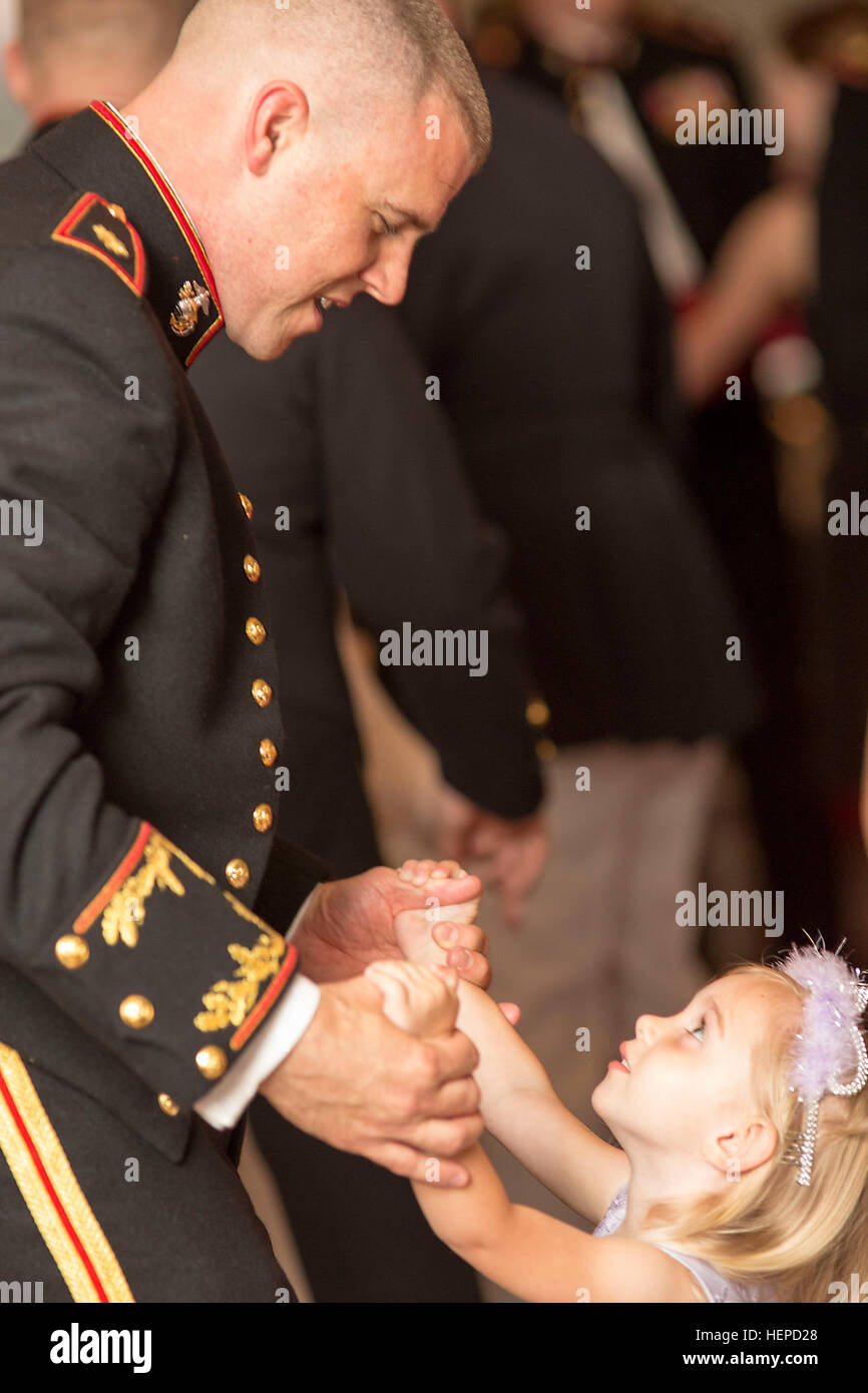 Maj. Jeremiah Hughes and daughter Grace, 3, share a slow dance during the Headquarters and Service Battalion, Headquarters Marine Corps, Henderson Hall Daddy-Daughter Dance May 16, 2015, at the Sheraton Pentagon City Hotel in Arlington, Va. (Joint Base Myer-Henderson Hall PAO photo by Damien Salas) Princesses and their Prince Charmings dance the night away 150516-A-DZ999-061 Stock Photo