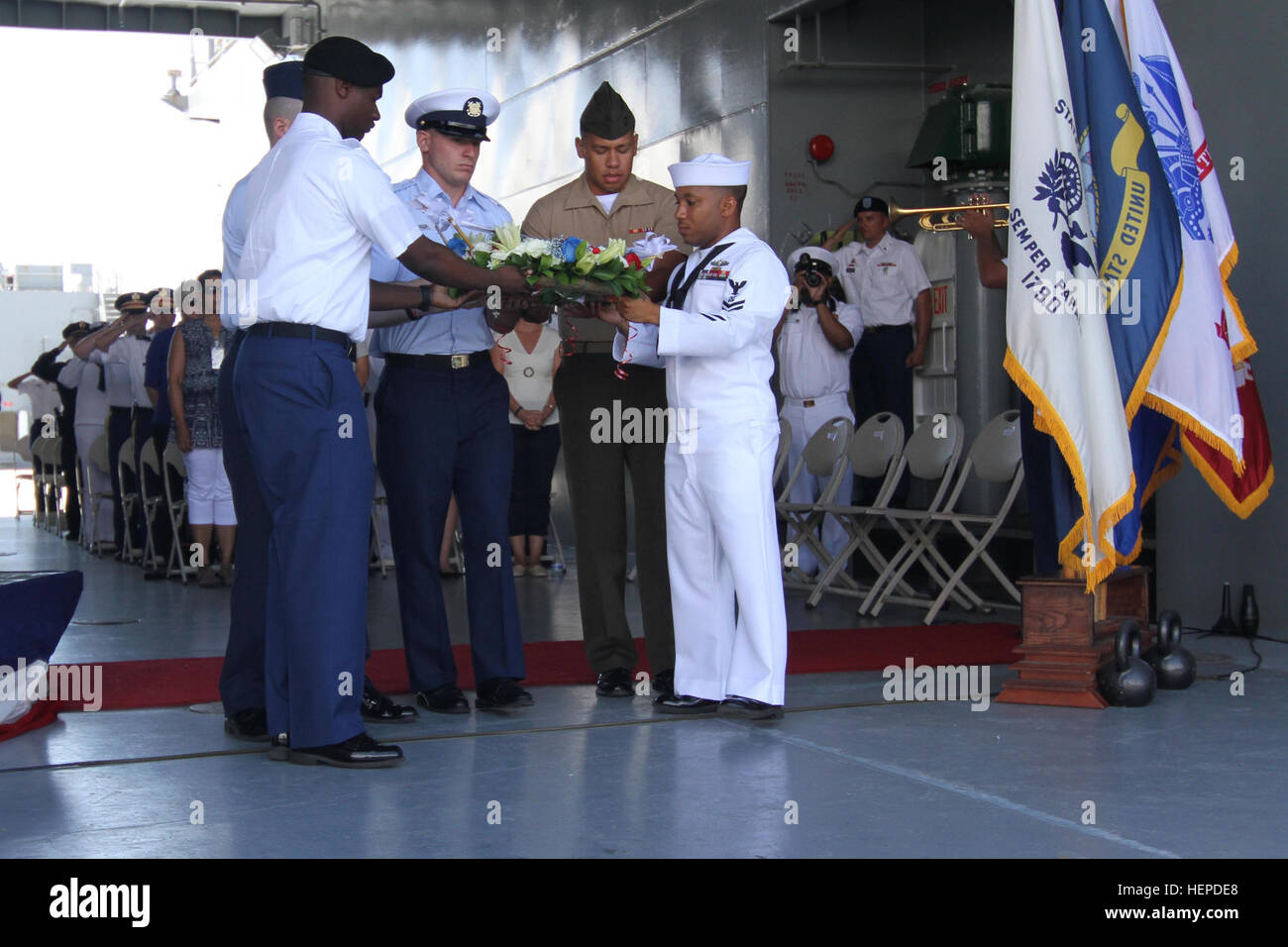 The youngest service member from each of the five U.S. military branches carried a memorial wreath down the ramp of U.S. Army Vessel Lt. Gen. William B. Bunker (Logistic Support Vessel 4) during the 71st West Loch Disaster Remembrance Ceremony to the waters of West Loch as a sign of respect and remembrance at Joint Base Pearl Harbor-Hickam, May 21, 2015. This was the second largest tragedy in Pearl Harbor during WWII. Hawaii community, service members memorialize those lost at West Loch 150521-A-AY884-142 Stock Photo
