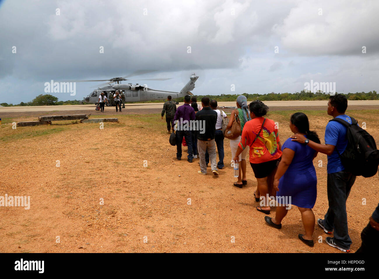 150522-A-BK746-184 PUERTO CABEZAS, Nicaragua (May 22, 2015) Nicaraguan citizens wait to board an MH-60s Sea Hawk helicopter assigned to Helicopter Sea Combat Squadron (HSC) 22 Sea Knights,  during Continuing Promise 2015. Continuing Promise is a U.S. Southern Command-sponsored and U.S. Naval Forces Southern Command/U.S. 4th Fleet-conducted deployment to conduct civil-military operations including humanitarian-civil assistance, subject matter expert exchanges, medical, dental, veterinary and engineering support and disaster response to partner nations and to show U.S. support and commitment to  Stock Photo
