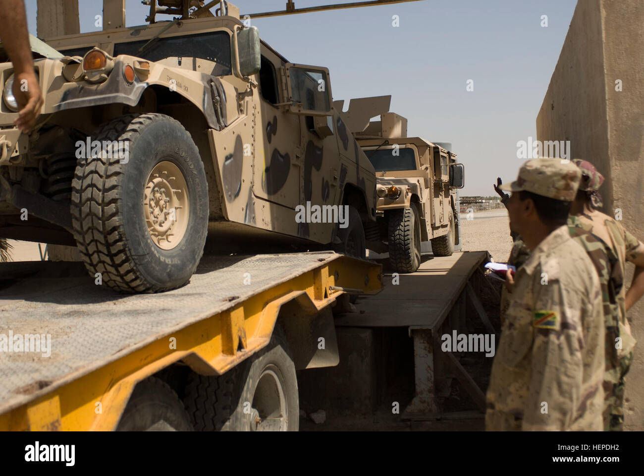 Humvee Push Iraqi soldiers push a Humvee off a flatbed during the Grease Monkey ...