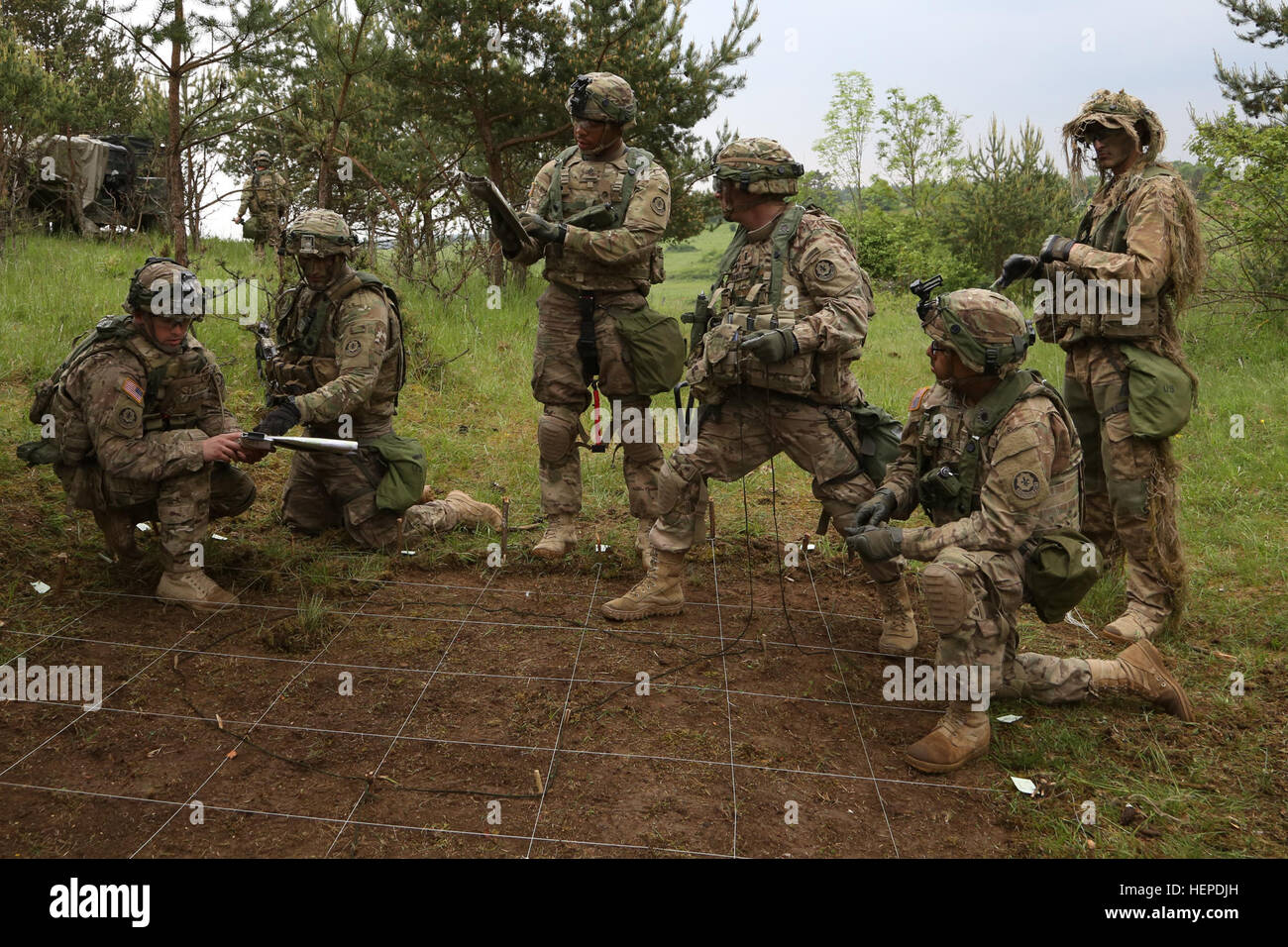 U.S. Soldiers of 3rd Squadron, 2nd Cavalry Regiment, set up a ground map for a combined arms rehearsal during exercise Combined Resolve IV at the U.S. Army’s Joint Multinational Readiness Center in Hohenfels, Germany, May 24, 2015.  Combined Resolve IV is an Army Europe directed exercise training a multinational brigade and enhancing interoperability with allies and partner nations. Combined Resolve trains on unified land operations against a complex threat while improving the combat readiness of all participants. The Combined Resolve series of exercises incorporates the U.S. Army’s Regionally Stock Photo
