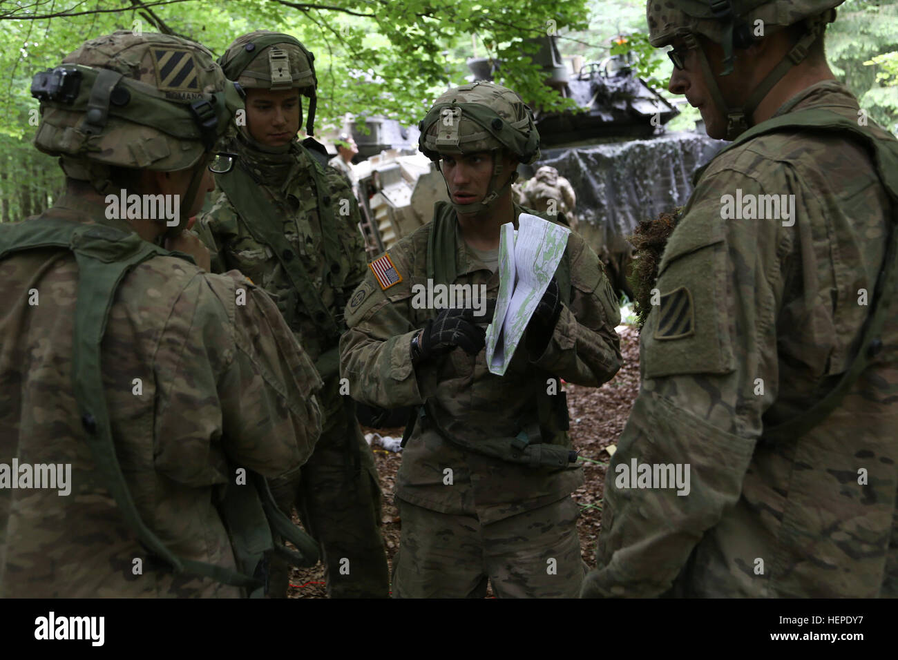 U.S. Soldiers of the 3rd Battalion, 69th Armor Regiment, 1st Armored Brigade Combat Team, 3rd Infantry Division review a map in preparation to build a sand table during exercise Combined Resolve IV at the U.S. Army’s Joint Multinational Readiness Center in Hohenfels, Germany, June 2, 2015. Combined Resolve IV is an Army Europe directed exercise training a multinational brigade and enhancing interoperability with allies and partner nations. Combined Resolve trains on unified land operations against a complex threat while improving the combat readiness of all participants. The Combined Resolve s Stock Photo