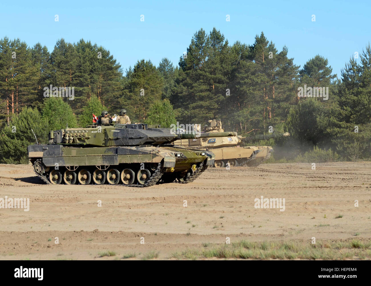 U.S. Army tank crews assigned to Company D, 2nd Battalion, 7th Infantry Regiment, 1st Armored Brigade Combat Team, Division, maneuver their M1A2 Abrams Battle Tanks alongside Danish Army tank