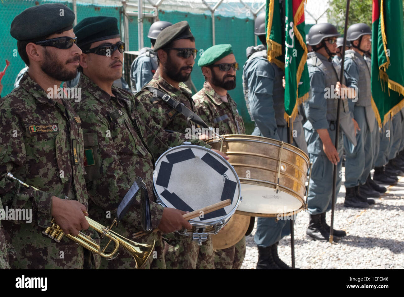 Afghan National Police officers and Afghan National Army band members line up in formation to conduct drill and ceremony before the start of an officer candidate school (OCS) graduation ceremony on Camp Nathan Smith, Kandahar, Afghanistan, May 19.  The graduation marks the first-ever OCS graduating class to come out of Kandahar province. Graduation at Camp Nathan Smith 110519-A-UJ825-031 Stock Photo