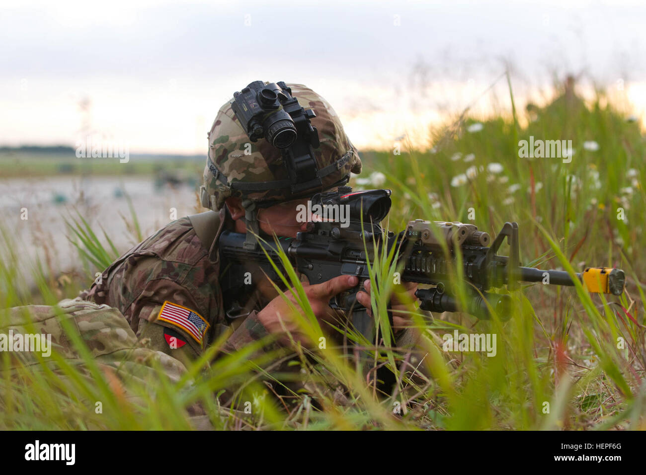 Pvt. Michael Simpkins, an infantryman with 1st Battalion, 503rd Infantry Regiment, 173rd Airborne Brigade, maintains security June 16, 2015, at Swidwin Air Base in Poland during Exercise Saber Strike 15. Encompassing more than 6,000 participants from 13 different nations, Saber Strike is a long-standing U.S. Army Europe-led cooperative training exercise. Designed to improve joint operational capability in a range of missions as well as preparing the participating nations and units to support multinational contingency operations, this year's exercise takes place across Estonia, Latvia, Lithuani Stock Photo