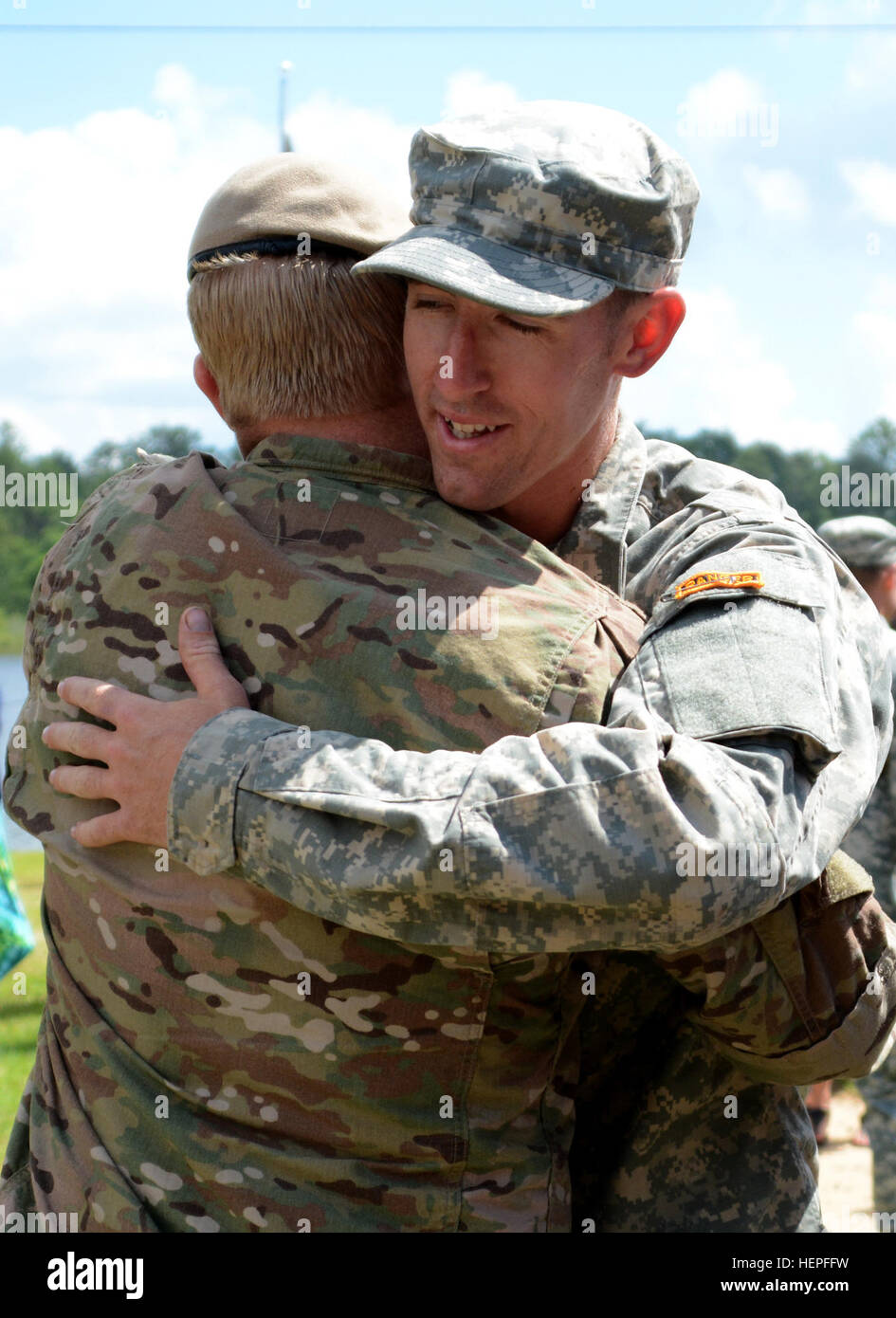 A Ranger from the 75th Ranger Regiment is congratulated by his leaders after receiving his Ranger Tab during the U.S. Army Ranger School graduation at Fort Benning, Ga., June 19. (Photo by Pfc. Parker Johnson, 75th Ranger Regiment documentation specialist) Ranger School Graduation 150619-A-VL627-045 Stock Photo