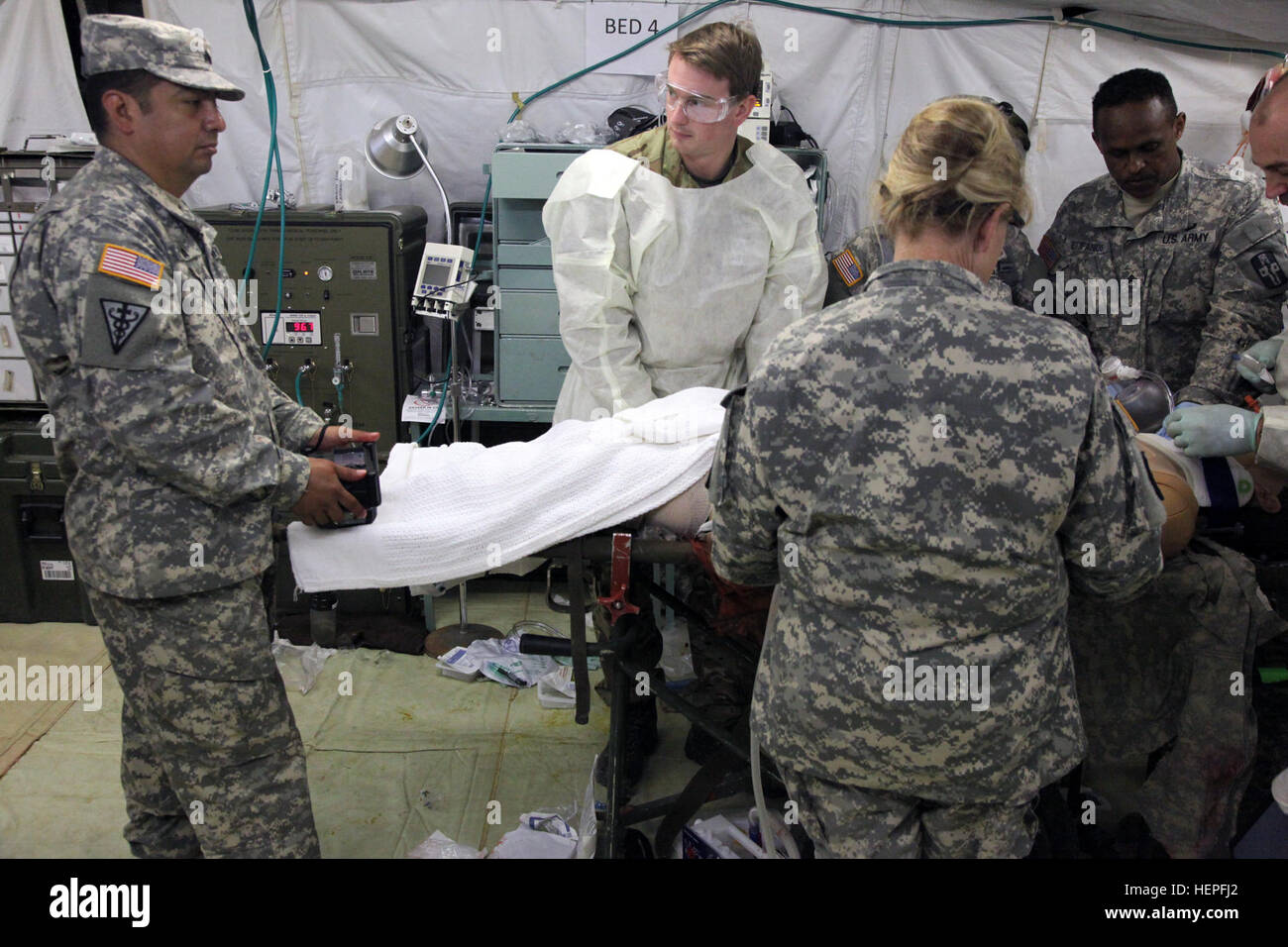 U.S. Army Reserve Sgt. Stanley Rivera, of Company A, 228th Combat Support Hospital, controls the simulated casualty’s breathing, vital signs and if the mannequin lives or dies with an observer/controller at Fort McCoy, Wis., June 20, 2015. Rivera determines if the simulated patient lives or dies depending on the medical care provided. Global Medic is the premier medical field-training event in the Department of Defense and is the only joint accredited exercise conceived, planned and executed by Army Reserve Soldiers. Service members from multiple DoD branches train together in a joint force en Stock Photo