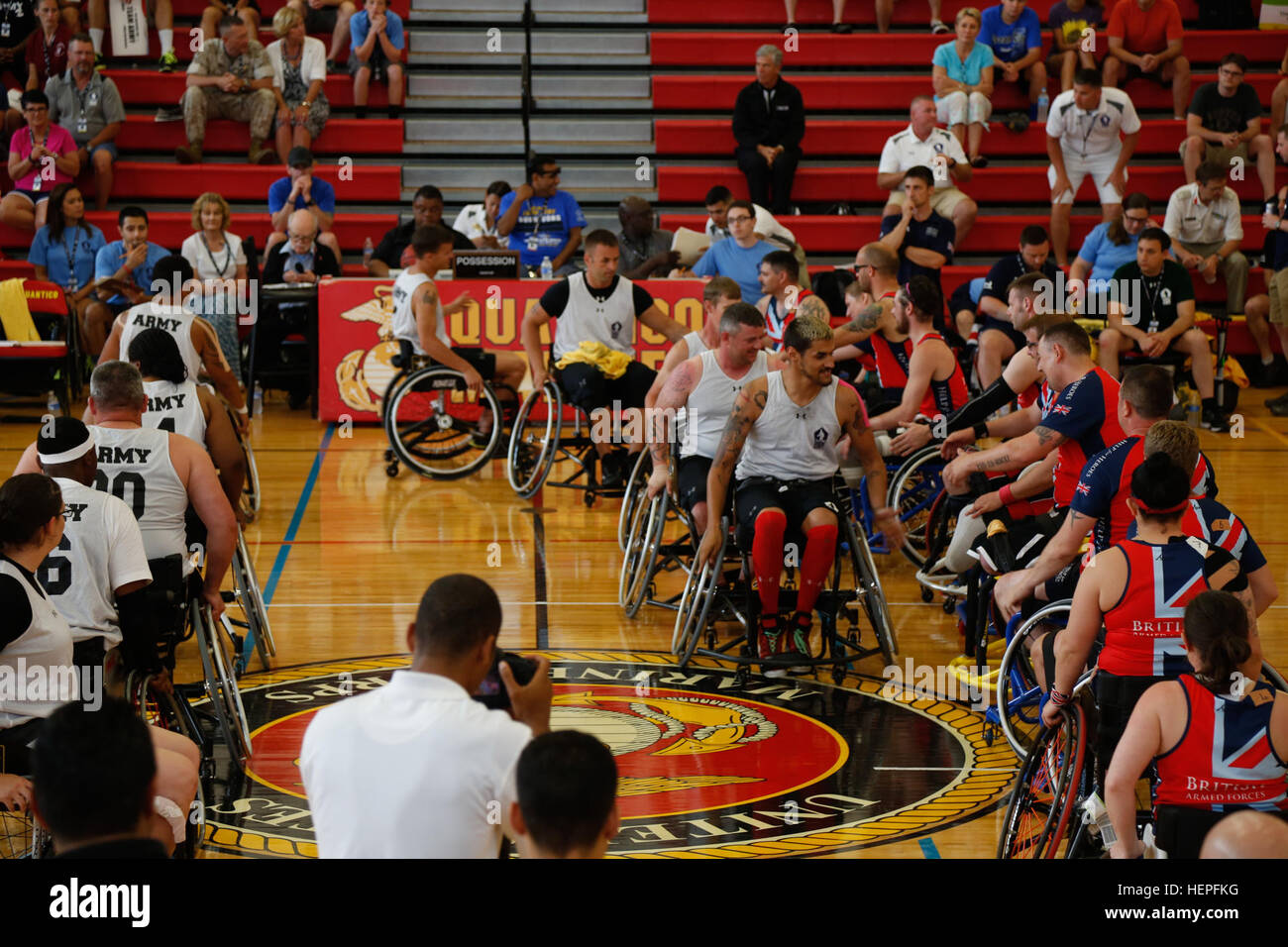 U.S. Army active duty and Veteran athletes shake hands with Team British Armed Forces before the wheelchair basketball competition during the 2015 Department of Defense Warrior Games at Barber Fitness Center, Marine Corps Base Quantico, Va., June 21, 2015. The 2015 DOD Warrior Games are held June 19-28. The games are an adaptive sports competition for wounded, ill and injured service members and Veterans. Approximately 250 athletes representing teams from the Army, Marine Corps, Navy, Air Force, Special Operations Command and the British Armed Forces will compete in archery, cycling, shooting, Stock Photo