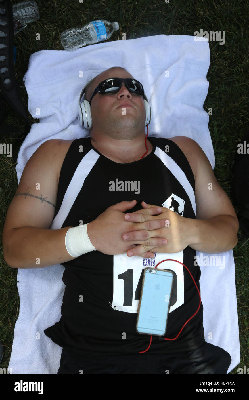 U.S. Army Reserves Sgt. Colten Harms, Warrior Transition Battalion, Fort Riley, Kan., gets some rest and some shade before he participates in the mens' shot put event at the 2015 Department of Defense Warrior Games, Marine Corps Base, Quantico, June 23, 2015. The 2015 DOD Warrior Games are held June 19-28. The Games are an adaptive sports competition for wounded, ill and injured service members and veterans. Approximately 250 athletes, representing teams from the Army, Marine Corps, Navy, Air Force, Special Operations Command and the British Armed Forces will compete in archery, cycling, field Stock Photo