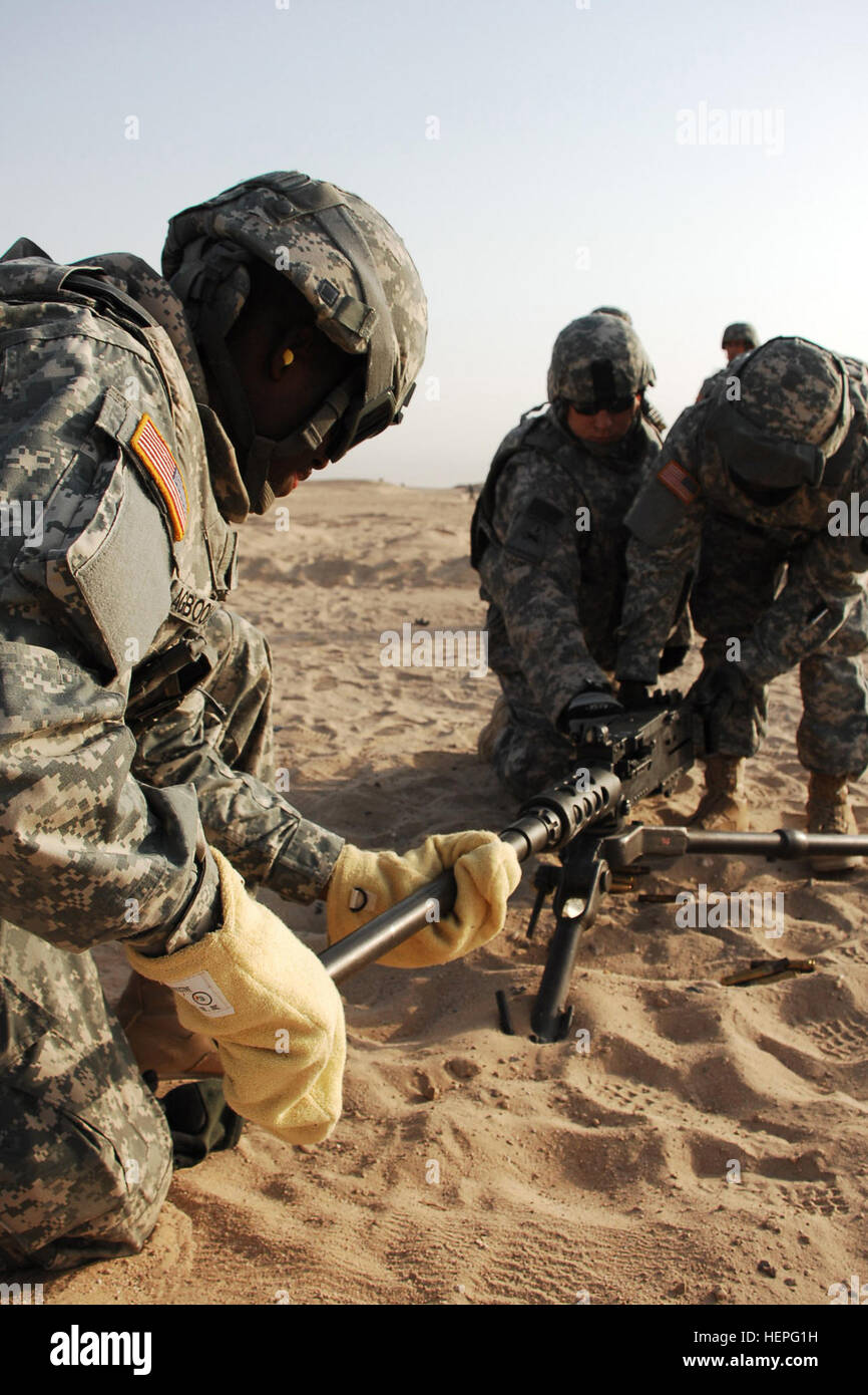 A Soldier wears gloves to protect himself from the heat from the