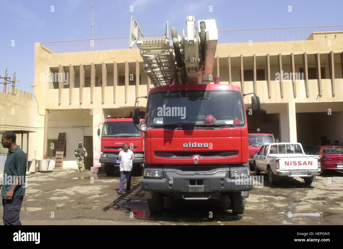A fire truck parked outside a fire station in Baghdad, Iraq on April 23, 2003. U.S. Army Civil Affairs soldiers made a visit to the station along with Baghdad's new interim Fire Chief Dr. Ali Saeed Sadoon. Civil Affairs soldiers are helping the city hire firefighters and get equipment back up and running.  U.S. forces are in Iraq in support of Operation Iraqi Freedom(OIF). OIF is the multinational  coalition effort to liberate the Iraqi people, eliminate Iraq's weapons of mass destruction and end the regime of Saddam Hussein. (U.S. Army photo by Staff Sgt. Kevin P. Bell) (Released) Iraqi Renau Stock Photo