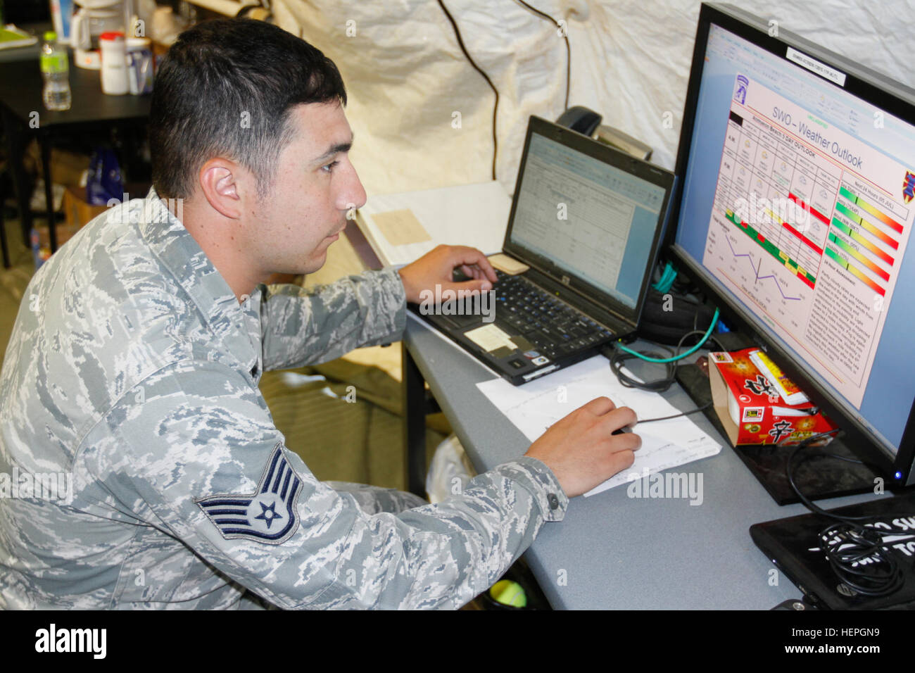 Air Force Staff Sgt. Anthony Chavis, battlefield weather forecaster for 18th Weather Squadron, Fort Bragg, N.C., reviews the five-day forecast for possible changes during the Combined Joint Logistics Over-the-Shore exercise at Anmyeon Beach, Republic of Korea, July 5, 2015. CJLOTS 2015 is an exercise designed to train U.S. and ROK services members to accomplish vital logistical measures in a strategic area while strengthening communication and cooperation in the U.S.-ROK alliance. (U.S. Army photo by Staff Sgt. Chris Perkey) CJLOTS Weather Center 150705-A-ZU617-007 Stock Photo