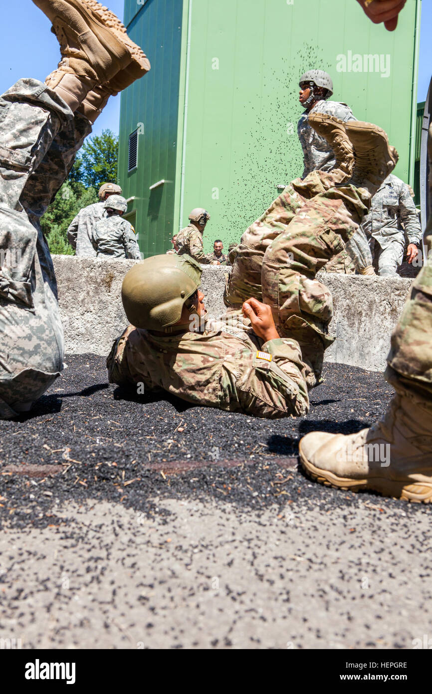 American Paratroopers practice parachute landing falls during International Jump Week (IJW), Ramstein Air Base, Germany, July 6, 2015. The 435th Contingency Response Group hosts IJW annually, to build global partnerships, foster camaraderie between U.S. and international paratroopers, and to exchange current tactics, techniques and procedures pertaining to Airborne Operations (Static Line and Military Free Fall).  (U.S. Army Photo By Staff Sgt. Justin P. Morelli / Released) 435th CRG's International Jump Week 150706-A-PP104-055 Stock Photo