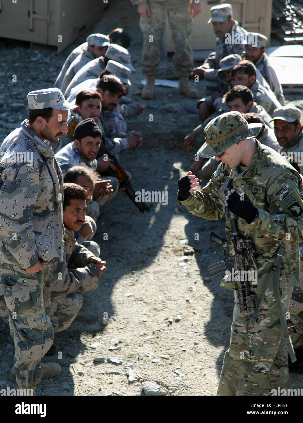 Afghan Border Patrol soldiers receive 'cold load' training from U.S. Army soldiers. A U.S. Army soldier is simulating how to properly load and unload a CH-47 Chinook on Forward Operating Base Joyce, Kunar province, Afghanistan, March 9, 2011. Supply Drop in Kunar Province 385406 Stock Photo