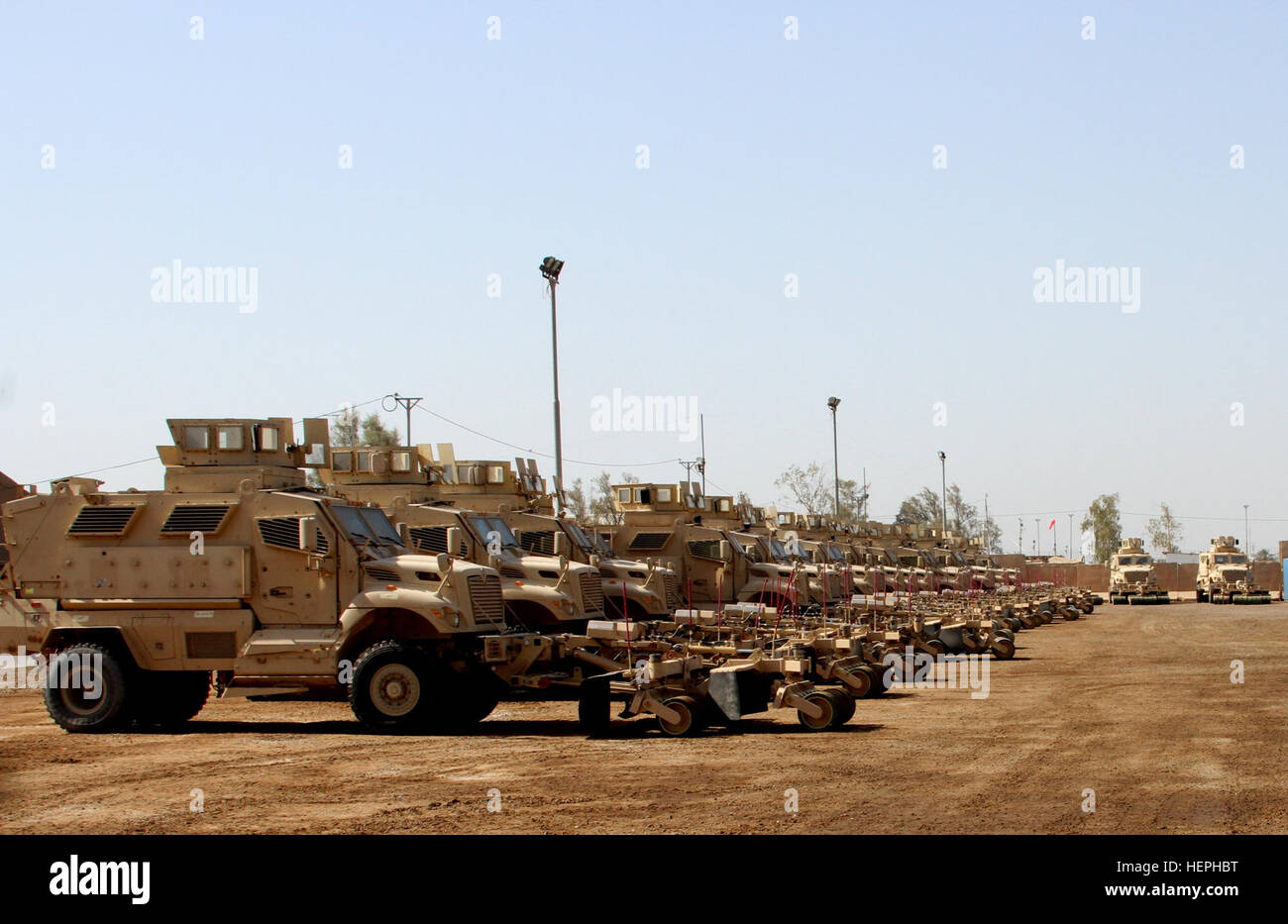 Iraqi security forces receive a shipment of 30 MaxxPro mine-resistant, ambush-protected (MRAP) vehicles with mine-roller attachments at Camp Taji, Iraq, July 13, 2015. The MRAPs are part of the Iraq Train and Equip Fund used to assist in the fight against the Islamic State of Iraq and the Levant. The 310th Advise and Assist Team, 13th Sustainment Command (Expeditionary) and the 1st Sustainment Command (Theater) supervised the delivery of the vehicles in support of Combined Joint Task Force – Operation Inherent Resolve. (U.S. Army photo by Staff Sgt. Brian McDermott/Released) Iraqi security for Stock Photo