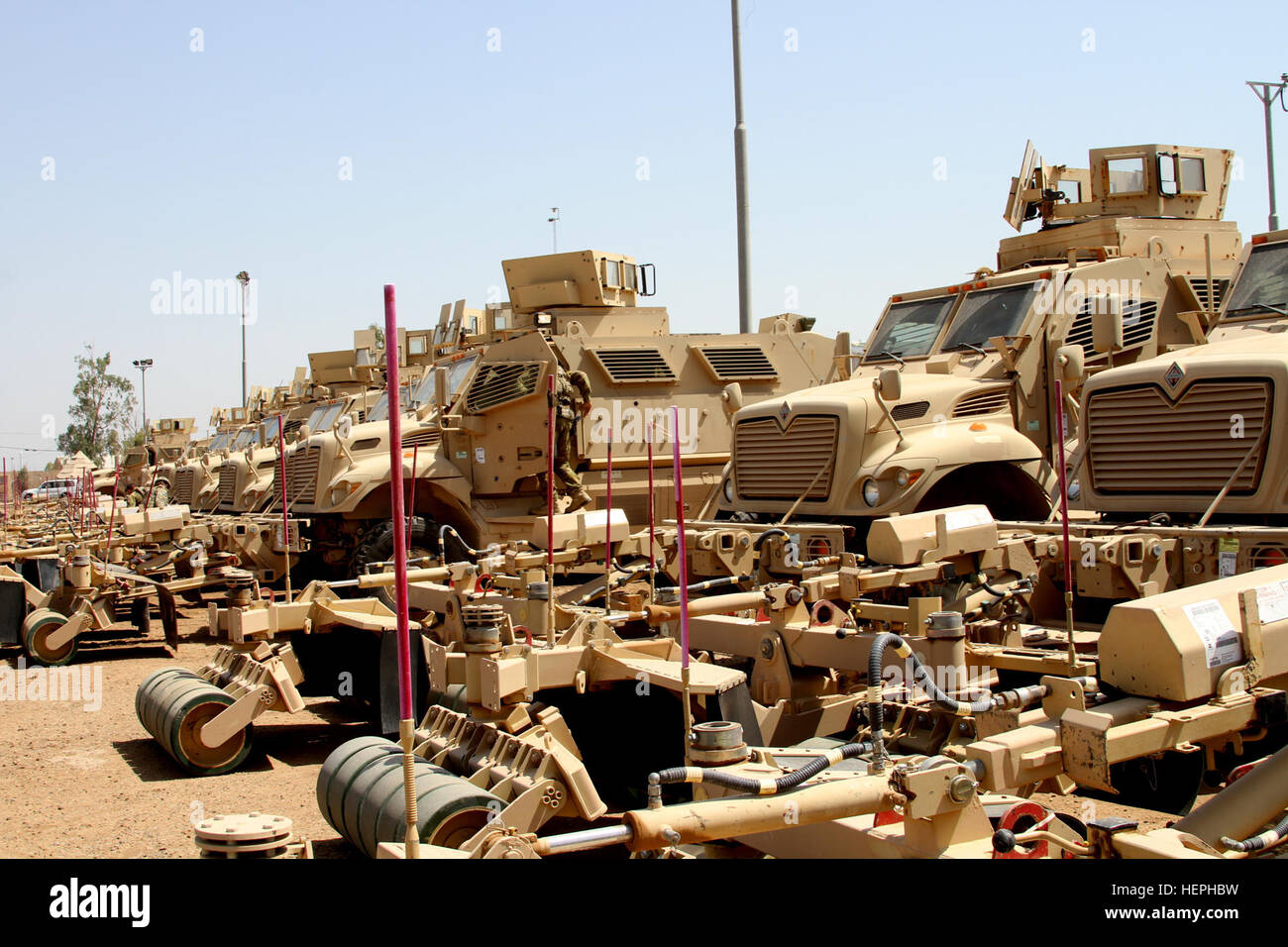 Iraqi security forces receive a shipment of 30 MaxxPro mine-resistant, ambush-protected (MRAP) vehicles with mine-roller attachments at Camp Taji, Iraq, July 13, 2015. The MRAPs are part of the Iraq Train and Equip Fund meant to assist in the fight against the Islamic State of Iraq and the Levant. The 310th Advise and Assist Team, 13th Sustainment Command (Expeditionary) and the 1st Theater Sustainment Command supervised the delivery of the vehicles in support of Combined Joint Task Force – Operation Inherent Resolve. (U.S. Army photo by Staff Sgt. Brian McDermott/Released) Iraqi security forc Stock Photo