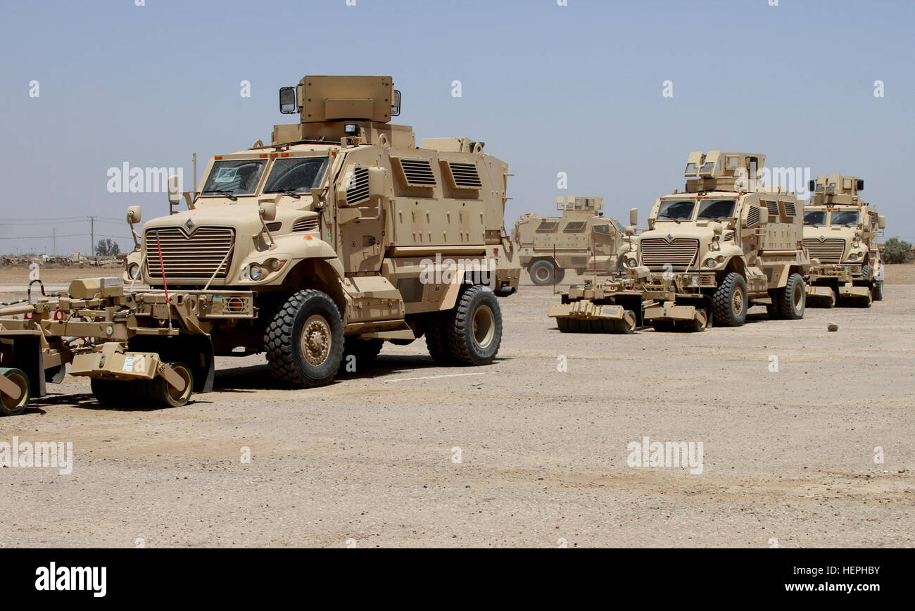 Iraqi security forces receive a shipment of 30 MaxxPro mine-resistant, ambush-protected (MRAP) vehicles with mine-roller attachments at Camp Taji, Iraq, July 13, 2015. The MRAPs are part of the Iraq Train and Equip Fund meant to assist in the fight against the Islamic State of Iraq and the Levant. The 310th Advise and Assist Team, 13th Sustainment Command (Expeditionary) and the 1st Theater Sustainment Command supervised the delivery of the vehicles in support of Combined Joint Task Force – Operation Inherent Resolve. (U.S. Army photo by Chief Warrant Officer 2 Christina Winfield/Released) Ira Stock Photo