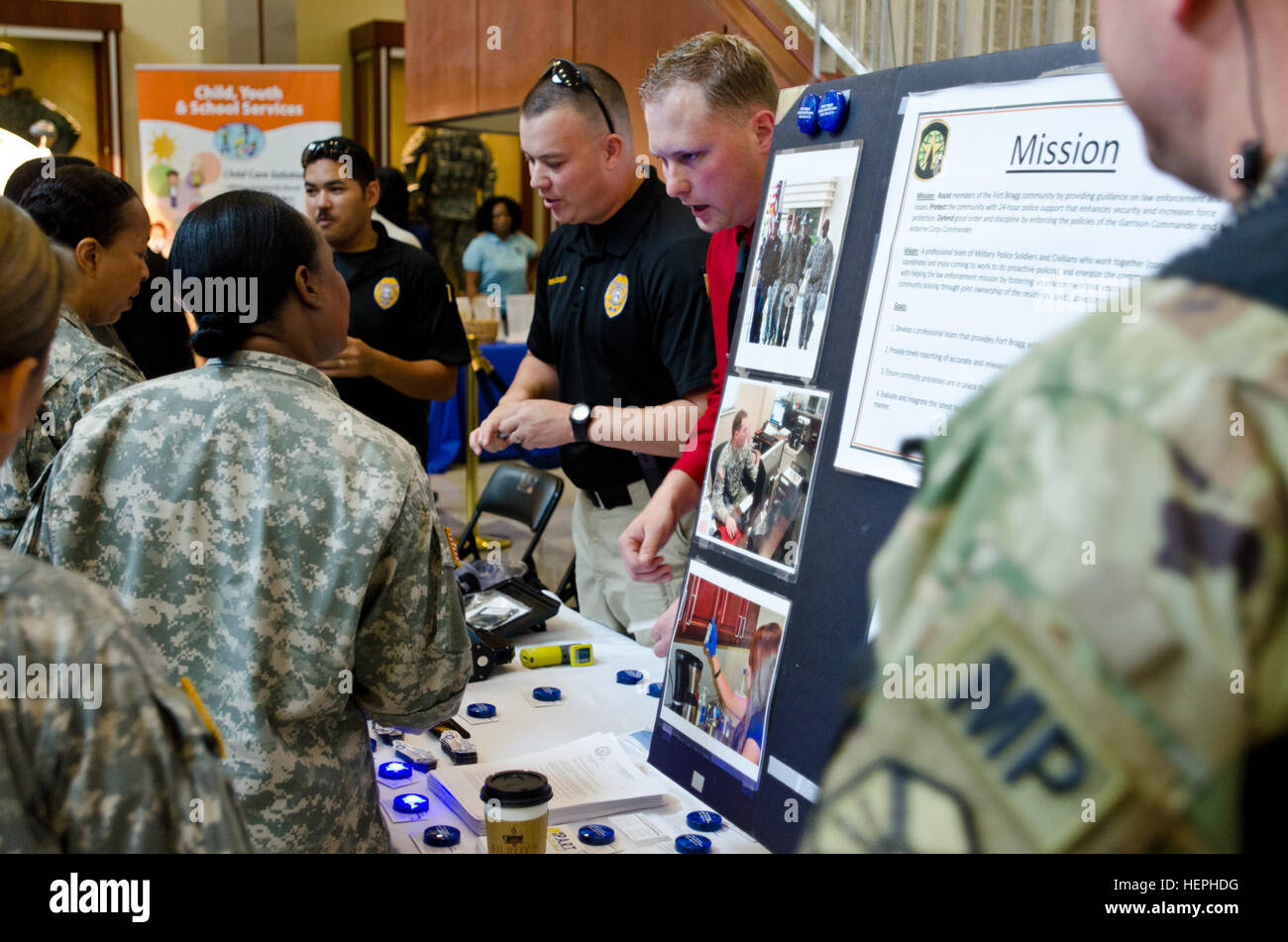 Officers with the Fort Bragg Provost Marshall and Law Enforcement Agency highlight different services and safety tips for Soldiers and civilians at their table as they participate in an educational awareness day of safety, hosted by the U.S. Army Reserve Command Safety directorate at FORSCOM/USARC headquarters July 14, 2015. With the help of several headquarters directorates, local law enforcement agencies, and community programs, 'Passport to Safety Day' promoted the operational readiness of the Army Reserve and provided safety insight to all those in attendance. (U.S. Army photo by Brian God Stock Photo