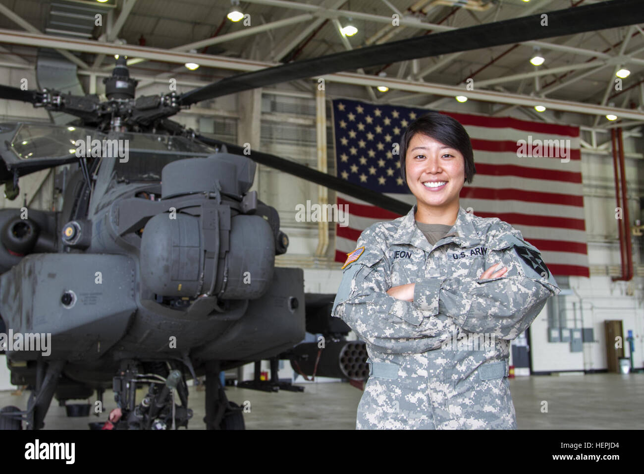 First Lt. Sarah Jeon, an AH-64 Apache helicopter pilot from the 4th Aerial Reconnaissance Battalion, 2nd Aviation Regiment, 2nd Combat Aviation Brigade, stands in front of an Apache on Aug. 13 at the 4-2nd Aviation Regiment hangar on Camp Humphreys, South Korea. Jeon was one of the first female Korean Apache pilots in the U.S. Army. 2nd CAB Women's Equality Day 081315-A-TU438-002 Stock Photo