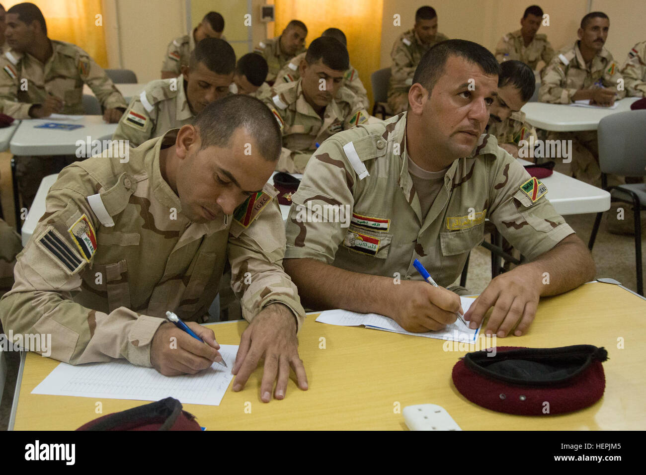 Iraqi soldiers attending the noncommissioned officer academy take a map reading test at Camp Taji, Iraq, Aug. 23, 2015. Task Group Taji spearheaded the academy concept in order to teach Iraqi NCOs how to train and care for their soldiers in different situations. Through professional development with the Iraqi NCOs, Combined Joint Task Force – Operation Inherent Resolve is empowering the Iraqi security forces in the fight against the Islamic State of Iraq and the Levant. (U.S. Army photo by Spc. Paris Maxey/Released) Iraqis attend NCO academy 150823-A-XM842-052 Stock Photo