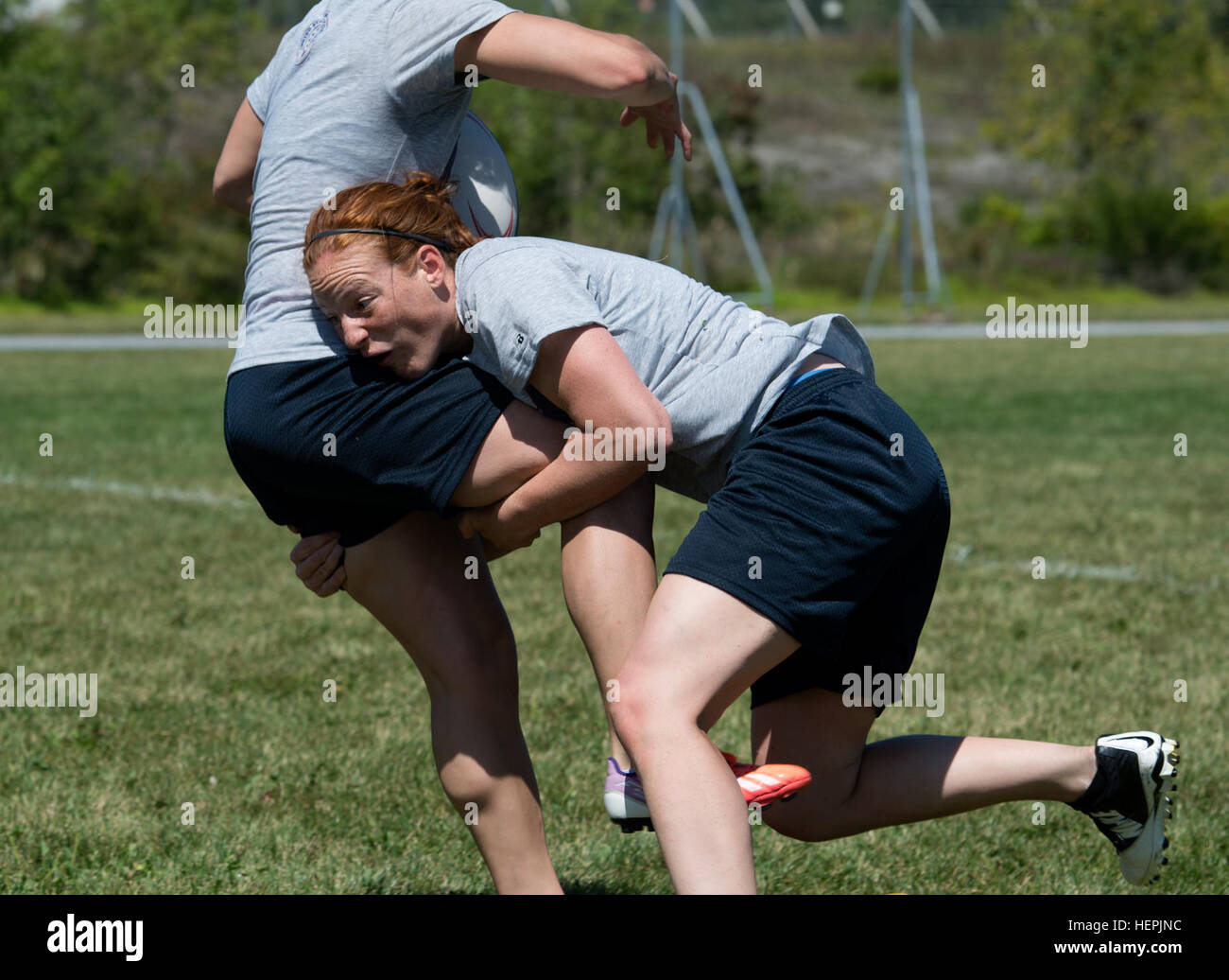 U.S. Air Force 2nd Lt. Emily Raney, from the U.S. Air Force Nuclear Weapons Center, Hill Air Force Base, Utah, makes a tackle during the first-ever Armed Forces Women's Rugby Team’s training camp at Fort Indiantown Gap. Pa., Aug. 25, 2015. Several woman on the team said they have been waiting years for Armed Forces Sports to stand up a program and have been playing in local clubs and tournaments in the meantime to keep their skills. (U.S. Army Photo by Sgt. Jose A. Torres Jr.) Armed Forces Women's Rugby 150825-A-ND255-204 Stock Photo