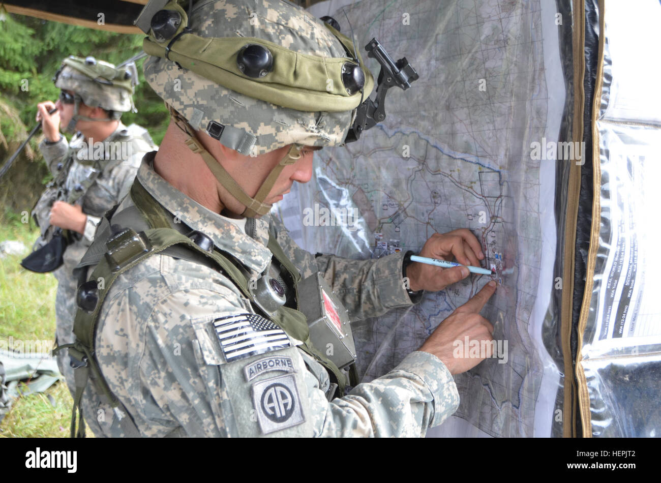 A U.S. Soldier of Brigade Headquarters and Headquarters Company, 1st Infantry Brigade, 82nd Airborne Division, notes a location on a map while working in a tactical operations center during exercise Swift Response 15 at the U.S. Army’s Joint Multinational Readiness Center in Hohenfels, Germany, Aug. 27, 2015. The purpose of the exercise is to conduct joint and combined training events in order to evaluate brigade and battalion level execution of strategic out-load in conjunction with allied partner nations through an intermediate staging base. Swift Response 15 is the U.S. Army’s largest combi Stock Photo