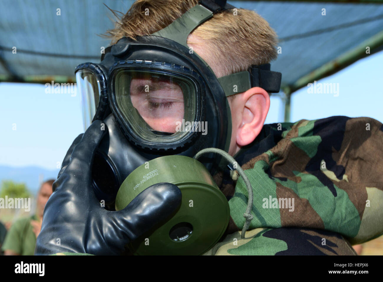 A U.S. Army paratrooper assigned to the 173rd Airborne Brigade’s chemical, biological, radiological and nuclear platoon checks his protective mask Sept. 1, 2015 before entering a tear-gas chamber during bilateral exercise Toxic Dragon in Rieti, Italy. Toxic Dragon brought together troops from the 173rd Airborne and the Italian Army’s 7th CBRN Regiment to share techniques and improve interoperability. (Photo by VI Specialist Elena Baladelli/released) Exercise Toxic Dragon 150901-A-II094-013 Stock Photo