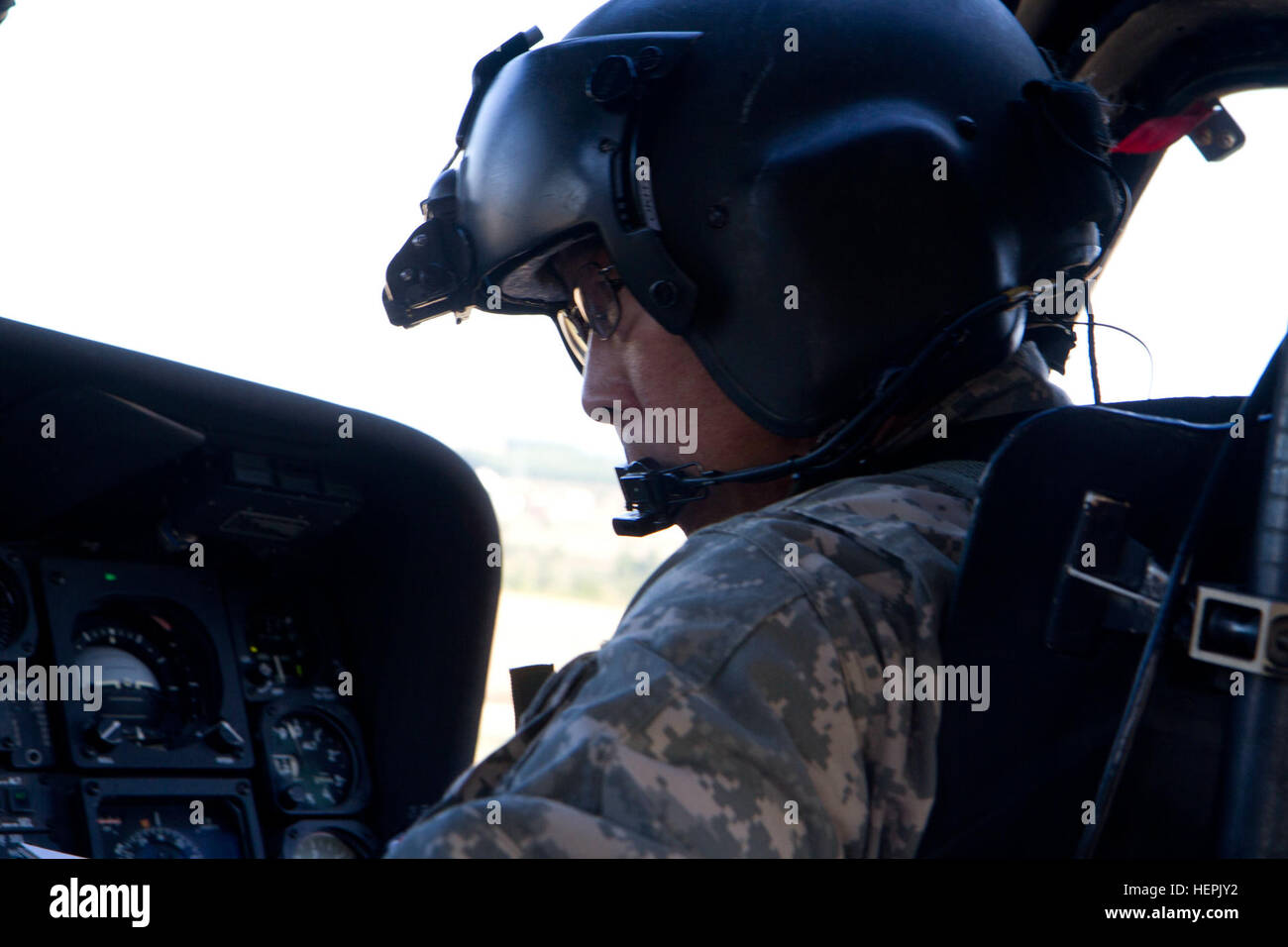 U.S. Army Reserve Chief Warrant Officer 4 Eugene Okita, a UH-60 Black Hawk pilot from A Company, 2nd Battalion, 238th Aviation Regiment, out of Los Alamitos, Calif., prepares to fly a UH-60 Black Hawk with a collapsible bambi bucket during aerial firefighting training, Sept. 6, 2015, at a lake near Mitrovica, Kosovo. The Multinational Battle Group-East Southern Command Post conducted the training in order to certify additional flight crews to perform this type of mission, and take advantage of an opportunity to develop their team members and build skills that will serve them throughout their m Stock Photo