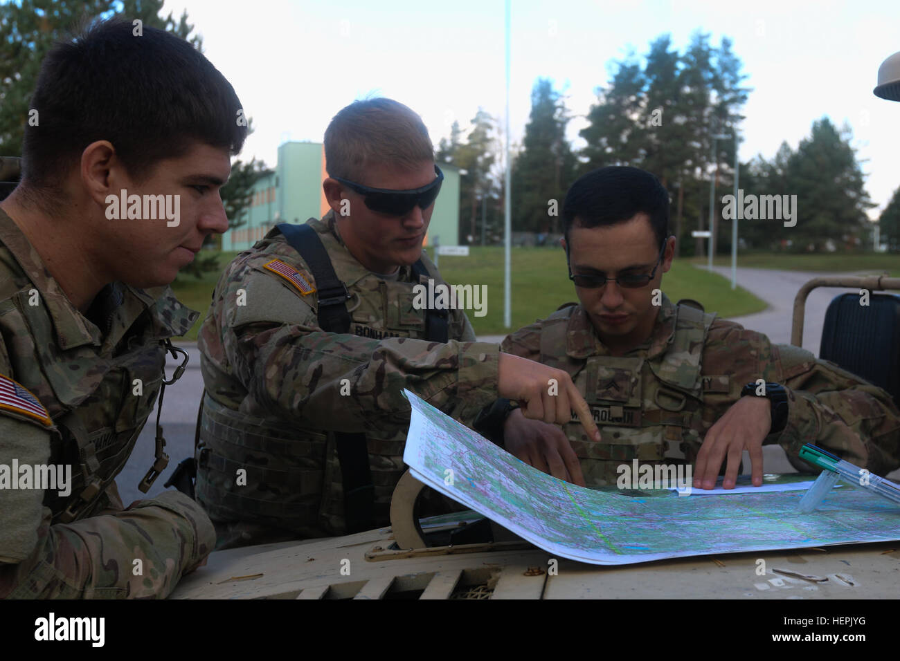 Spc. Skylar M. McMahon (left to rigth), Pvt. Michael V. Bonham, and Cpl. Evan A. Marroquin, Soldiers assigned to Destined Company, 2nd Battalion, 503rd Infantry Regiment, 173rd Airborne Brigade, plot coordinates on a map during a land navigation course exercise in Voru, Estonia, Sept. 9, as part of Swift Bayonet, a training exercise that is part of Operation Atlantic Resolve. The hands-on practical exercises ensured confidence for real-world scenarios factoring in weather and terrain. (U.S. Army photo by Spc. Jacqueline Dowland, 13th Public Affairs Detachment) Land navigation course in Estonia Stock Photo