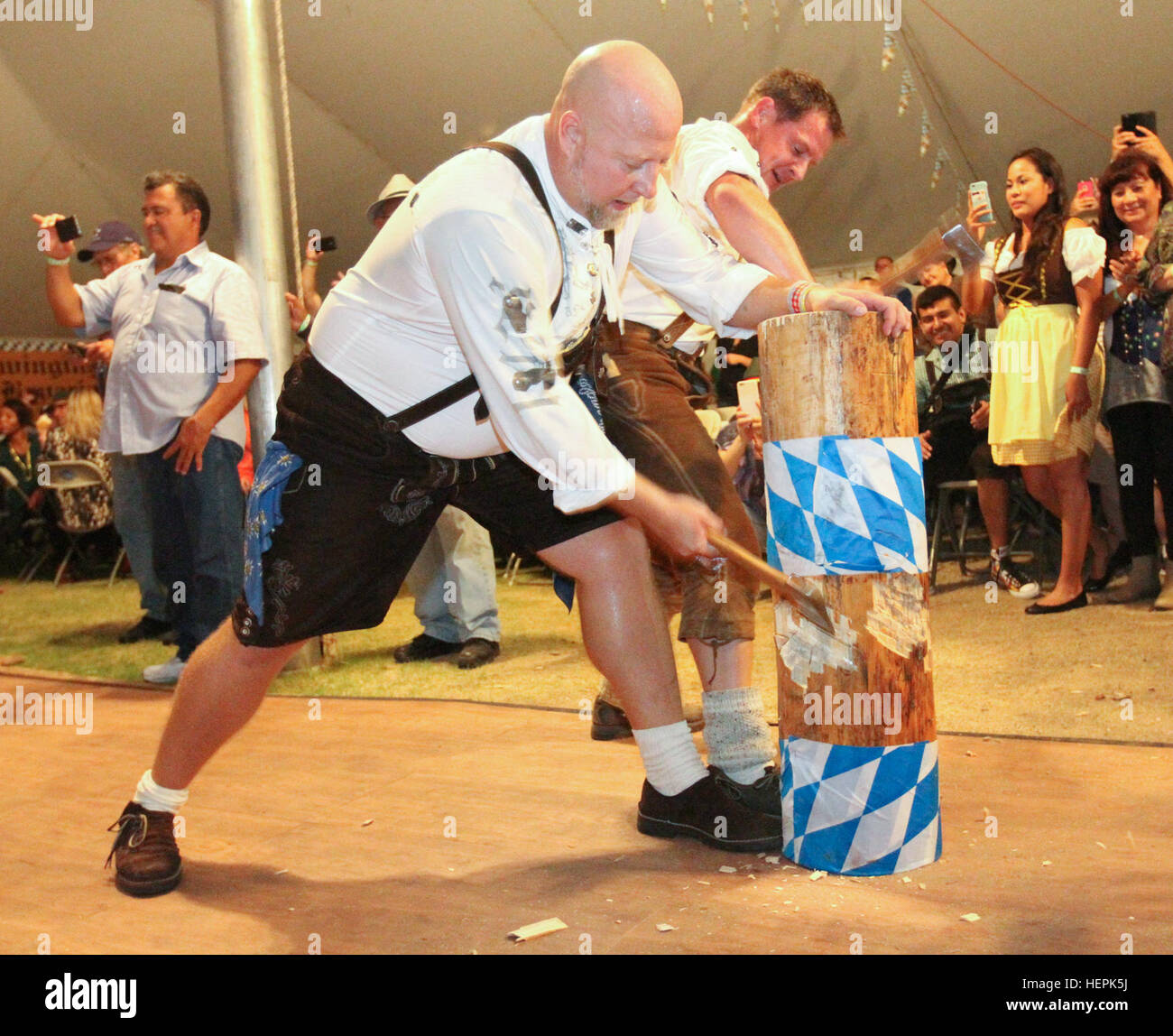 German Air Force Schuhplattler Dancers chop wood during the Holzhacker