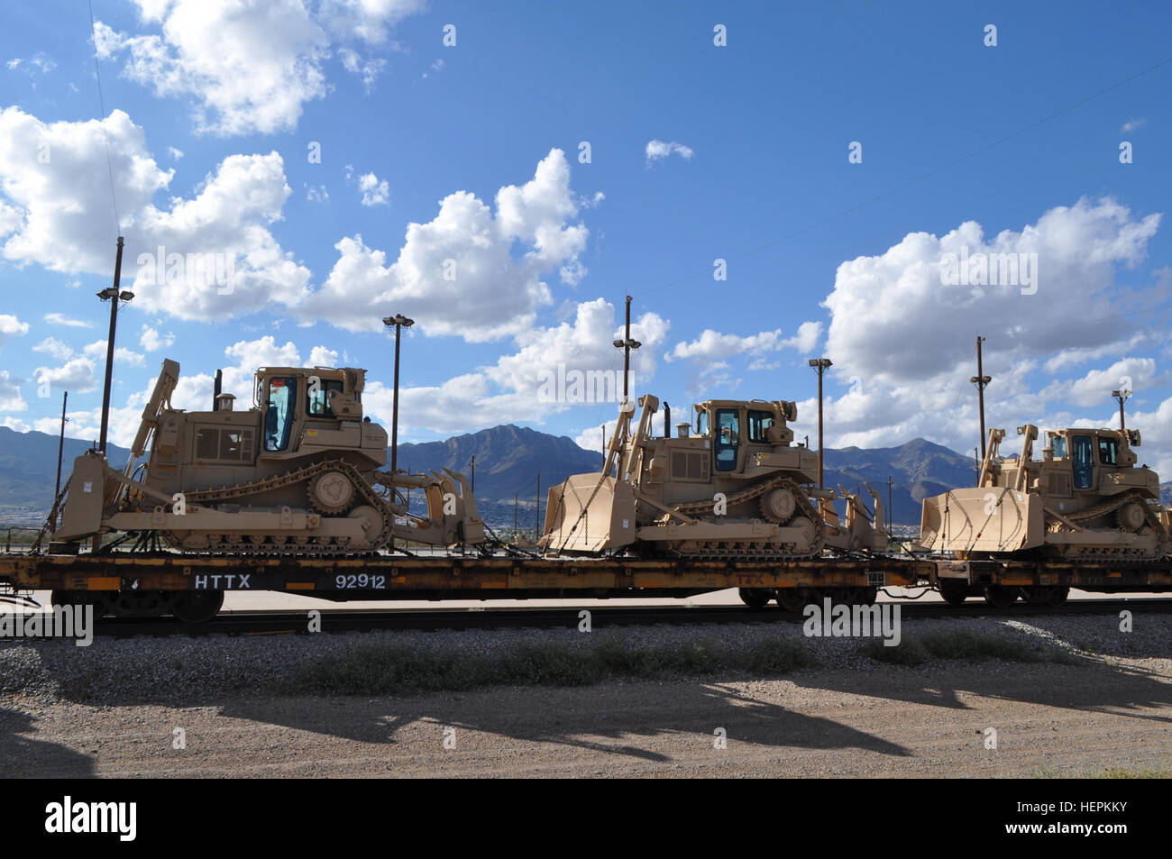 Three Caterpillar T9 bulldozers sit at the Fort Bliss rail yard