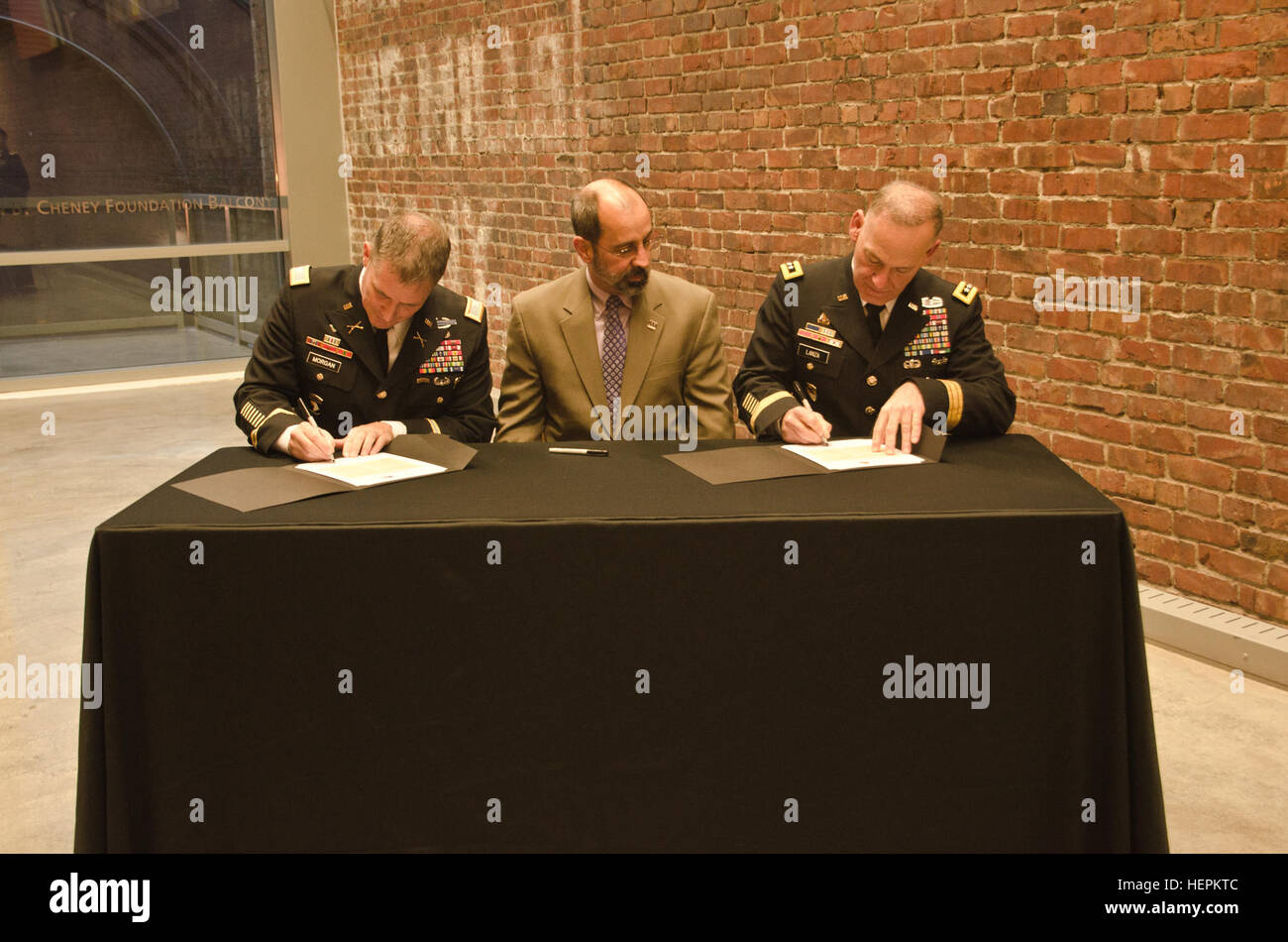 Col. Daniel S. Morgan, commander, Joint Base Lewis-McChord, left, Mark A. Pagano, chancellor, University of Washington Tacoma, center, and Lt. Gen. Stephen R. Lanza, commanding general, I Corps, JBLM, right, come together to sign partnership resolutions at the University of Washington Tacoma, Oct. 29, 2015. The partnership resolution allows for the military and the UW-T to work together to improve life in the South Sound region for all residents. (U.S. Army photo by Sgt. Jasmine Higgins, 28th Public Affairs Detachment) Resolution 151030-A-HS859-997 Stock Photo