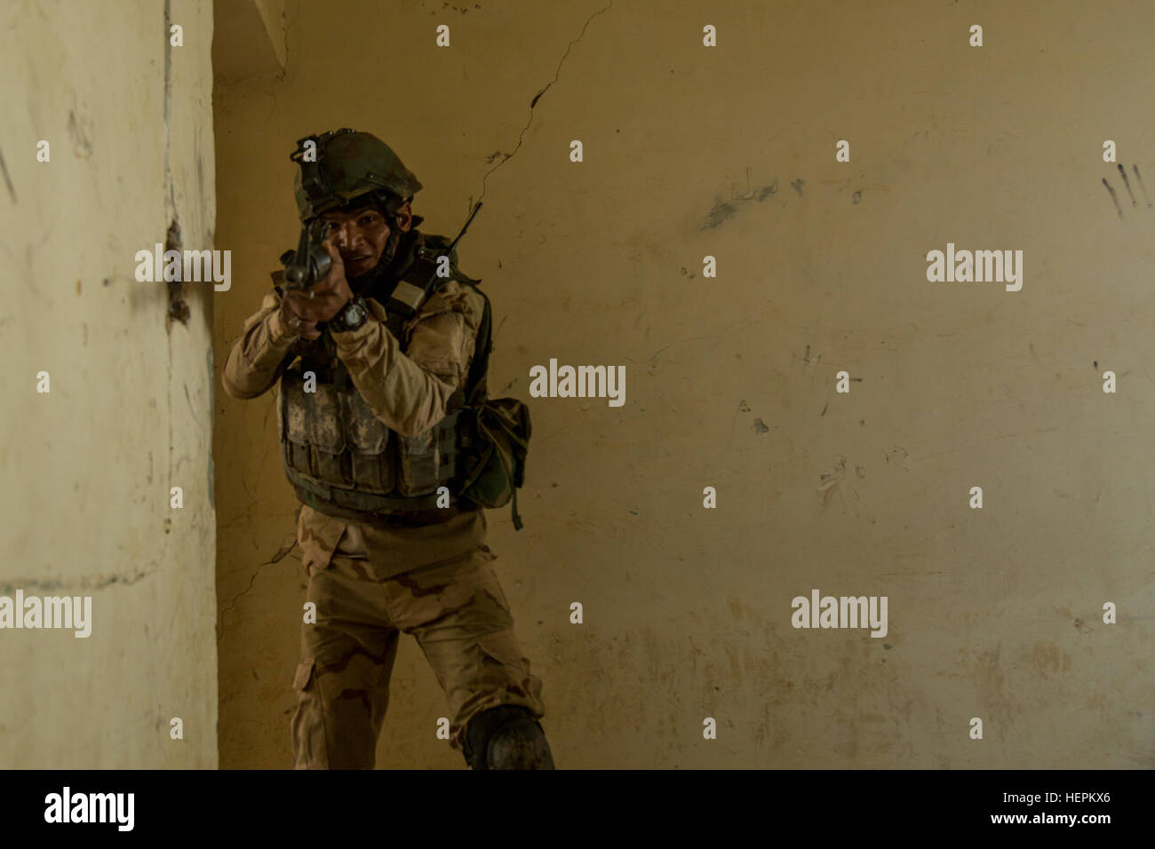 An Iraqi soldier assigned to 71st Iraqi Army Brigade clears a room during urban operations training at Camp Taji, Iraq, Nov. 4, 2015. The soldier participated in the training to learn how to properly clear buildings and populated areas during assaults against the Islamic State of Iraq and the Levant (ISIL). The training is part of the building partner capacity mission led by coalition members assigned to Task Group Taji, and part of Combined Joint Task Force – Operation Inherent Resolve’s mission to defeat ISIL and the threat they pose to Iraq, Syria, the region, and the wider international co Stock Photo