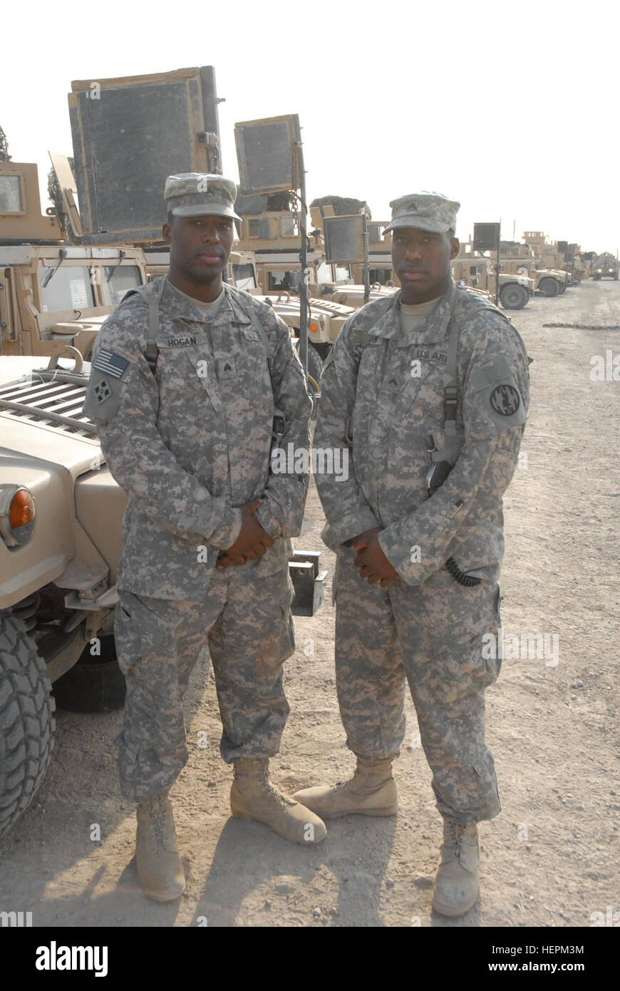 Sgt. Ray Hogan (left) and his brother, Cpl. Roland Hogan, natives of Long Branch, N.J., are both military police Soldiers assigned to the 978th Military Police Company and serving in Baghdad as they conduct Police Transition Team operations at local Iraqi police stations. The 978th MP Co. is deployed from Fort Bliss, Texas, and is currently assigned to the 716th Military Police Battalion, 18th Military Police Brigade, Multi-National Division - Baghdad. Brothers serve together as Baghdad 'cops' 113890 Stock Photo