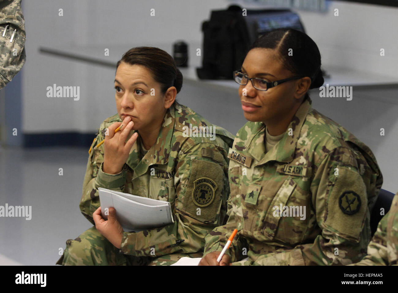 U.S. Army Reserve Soldiers Sgt. 1st Class Monica Waldron, Headquarters, United States Army Recruiting Command, Fort Knox, Ky., left and Sgt. Kancice Chavis, 535th Military Police Battalion, 290th Military Police Brigade, 200th Military Police Command, listen as fellow classmates of the Equal Opportunity Leaders Course determine who has to leave a 'sinking lifeboat' during the course's Life Raft Exercise at the 11th Theater Aviation Command's Headquarters  Nov. 18, 2015. (U.S. Army photo by Clinton Wood/Released). Leaders Course Activity creates biases awareness 151118-A-HX393-053 Stock Photo