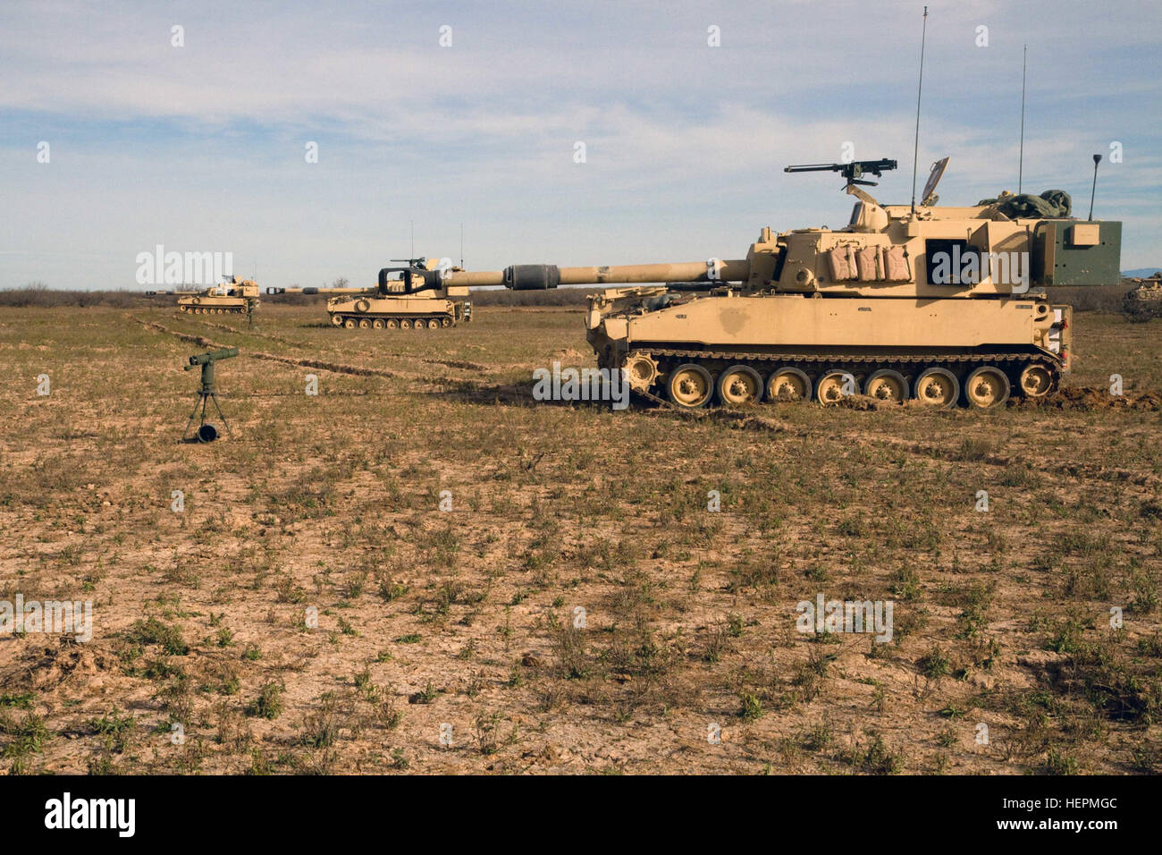 Three U.S. Army M109-A6 Paladin Self-Propelled Howitzers operated by A Battery, 4th Battalion, 27th Field Artillery, Division Artillery (DIVARTY), 1st Armored Division, stand ready to fire at the Dona Ana firing range just outside Fort Bliss, Texas, Dec. 7, 2015 during the first day of DART (Division Artillery Readiness Test). DART is a new, three-day exercise that will determine the readiness of DIVARTY FA units through live-fire exercises, react to contact, improvised explosive device (IED) defense and casualty and vehicle evacuation. (U.S. Army Photo by Sgt. James Avery, 16th Mobile Public  Stock Photo