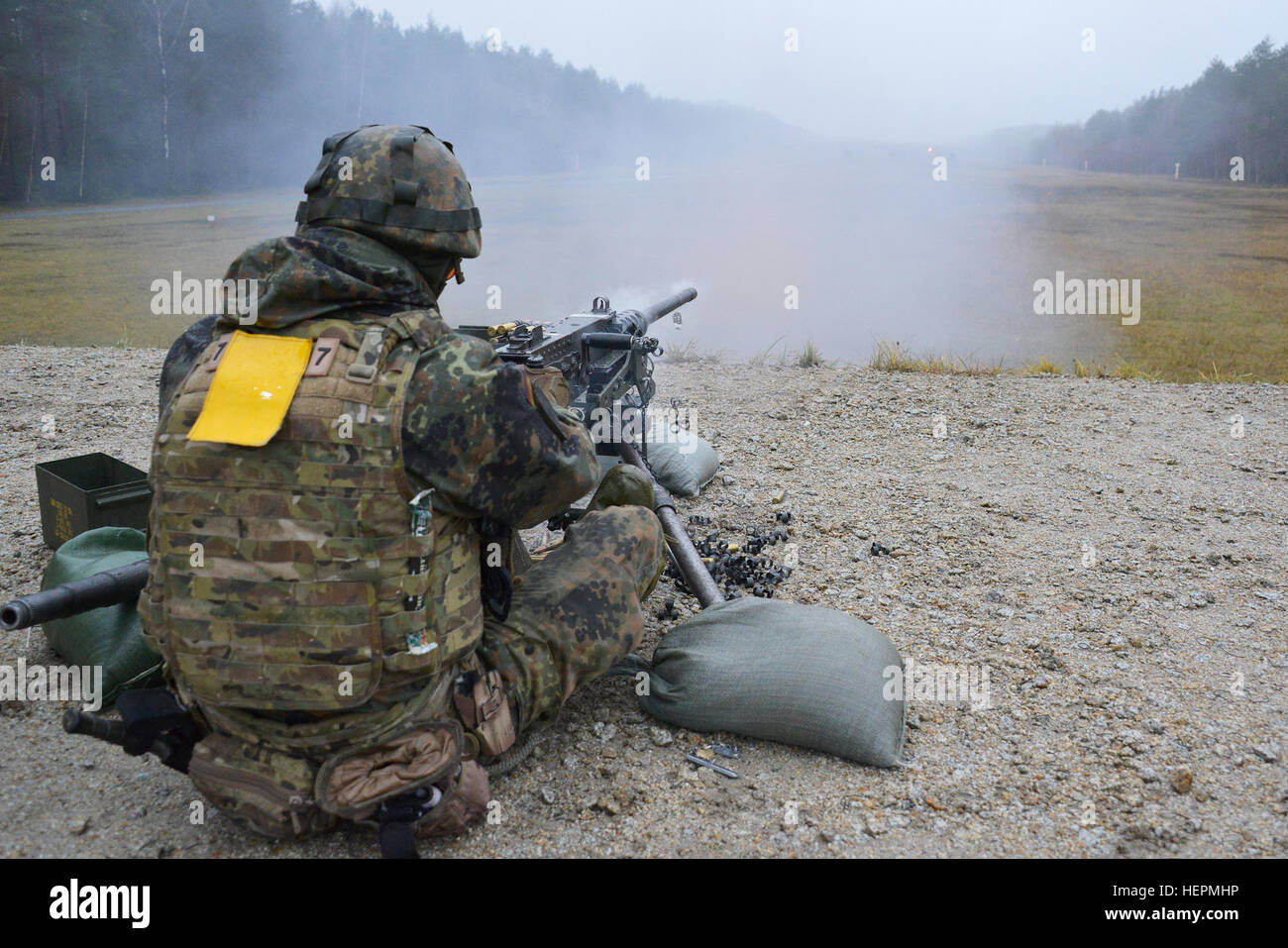 A German soldier fires a .50-caliber machine gun during a familiarization training on U.S. weapons at the 7th Army Joint Multinational Training Command Grafenwoehr Training Area, Germany, Dec. 9, 2015. (U.S. Army photo by Visual Information Specialist Gertrud Zach/released) CATC trains German soldiers on US weapons 151209-A-HE539-0376 Stock Photo