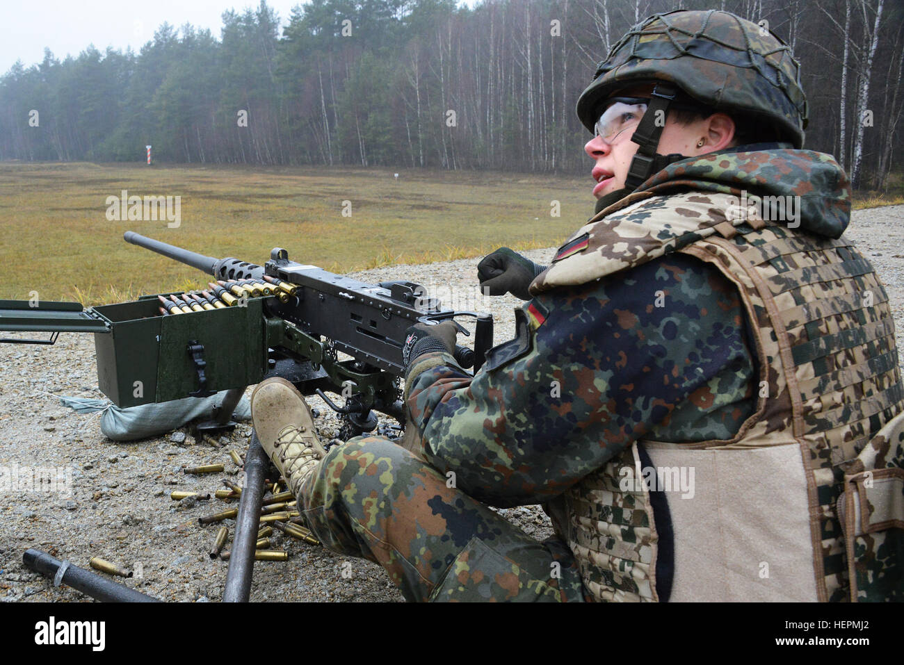 A German soldier fires a .50-caliber machine gun during a familiarization training on U.S. weapons at the 7th Army Joint Multinational Training Command Grafenwoehr Training Area, Germany, Dec. 9, 2015. (U.S. Army photo by Visual Information Specialist Gertrud Zach/released) CATC trains German soldiers on US weapons 151209-A-HE539-0478 Stock Photo