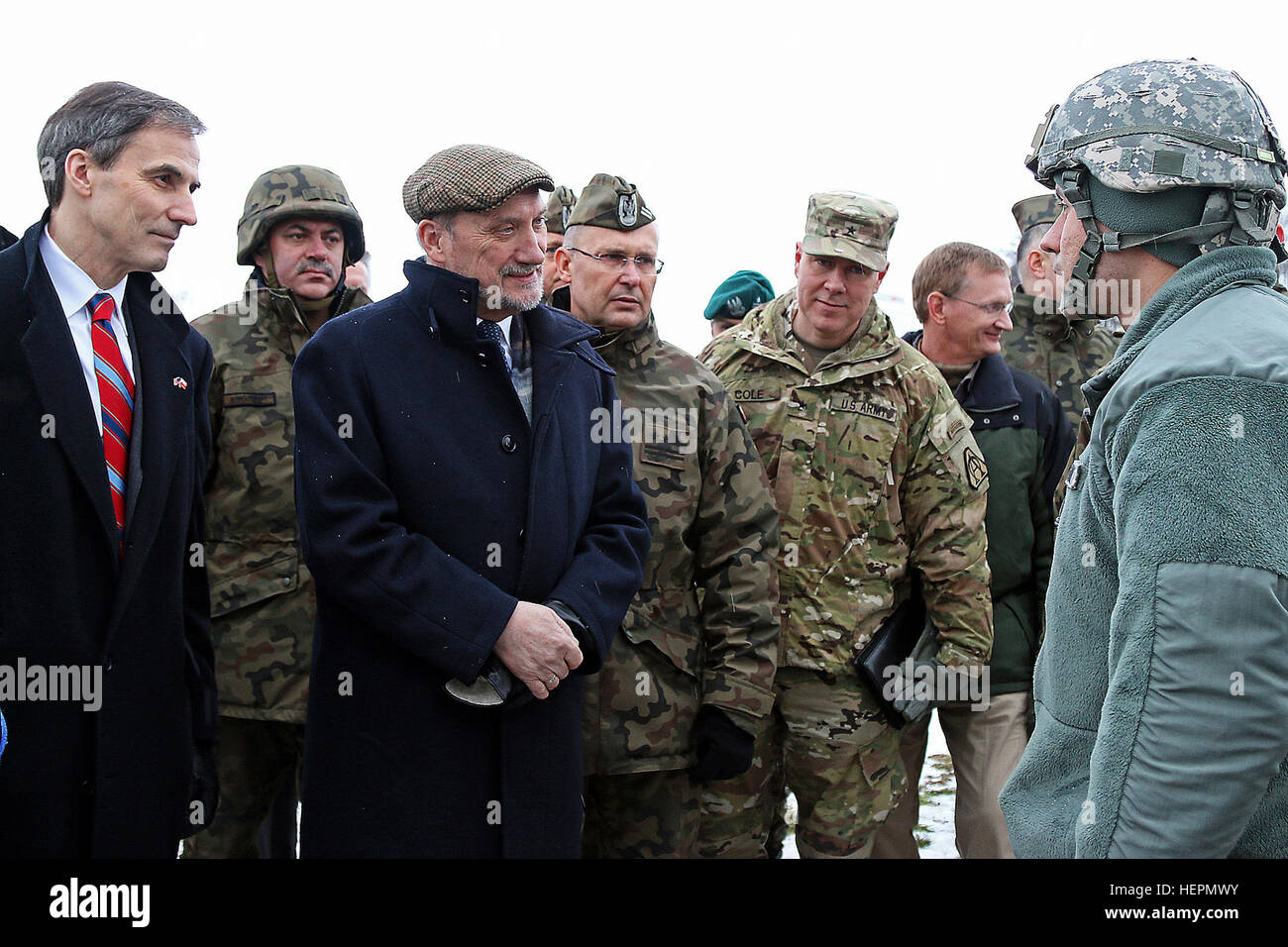 Paul Jones (far left), U.S. ambassador to Poland, Antoni Macierewicz (center with hands folded), Polish minister of defense, Col. Andrzej Dabrowski (third from right), commander of 3rd Air Defense Brigade, Polish army, Brig. Gen. William Cole (second from right), deputy commanding general of Research, Development and Engineering Command and commander of the U.S. Army Natick Soldier Systems Center, and Capt. David Chavez (far right), commander of A Battery, 5th Battalion, 7th Air Defense Artillery Brigade, speak together about capabilities of their various Patriot missile equipment during Panth Stock Photo