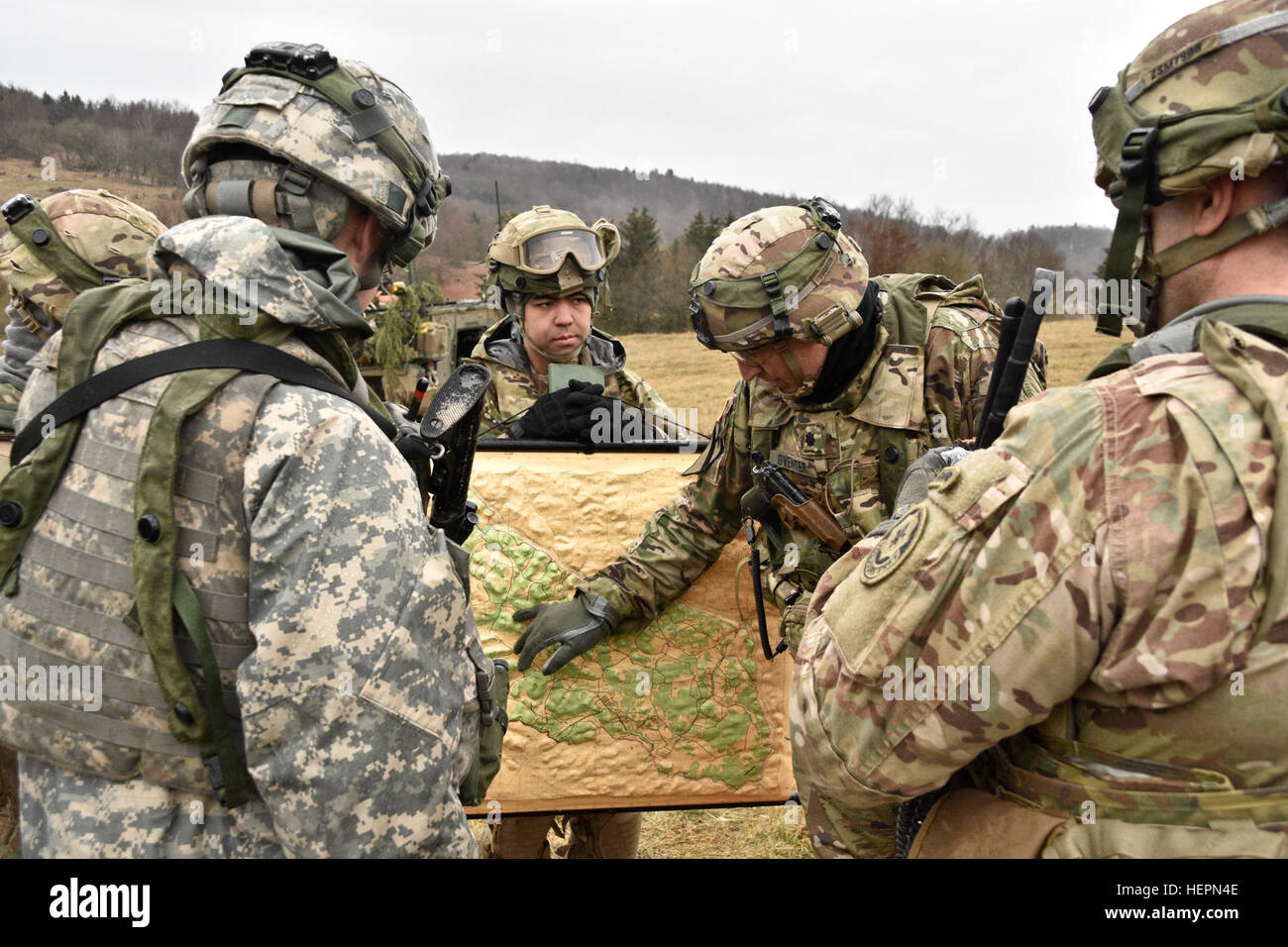 Lt. Col. Steven E. Gventer (middle), the Squadron Commander for 2nd Squadron (Cougars), 2nd Cavalry Regiment, points out the unit's position on a terrain map during a Combined Arms Rehearsal while participating in Exercise Allied Spirit IV, being held at the Joint Multinational Readiness Center located in Hohenfels, Germany, Jan. 28, 2016. The goal of the exercise is to prepare forces, in Europe, to operate together by exercising tactical interoperability and testing secure communications within NATO Alliance members and partner nations. (U.S. Army photo by Sgt. William A. Tanner) Allied Spiri Stock Photo
