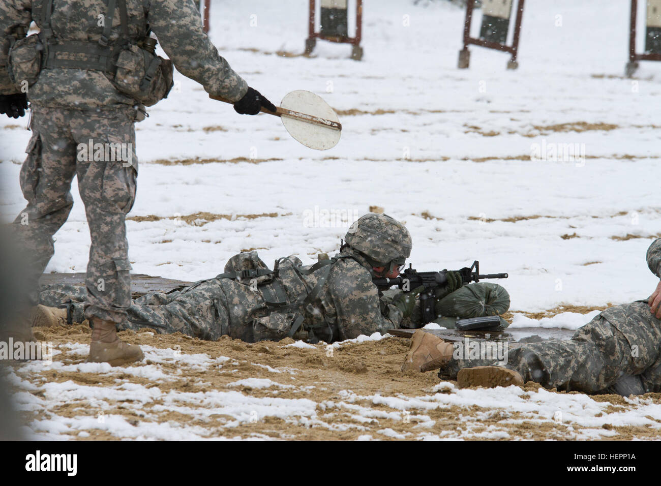 A U.S. Army Reserve range cadre gives instruction to a soldier within