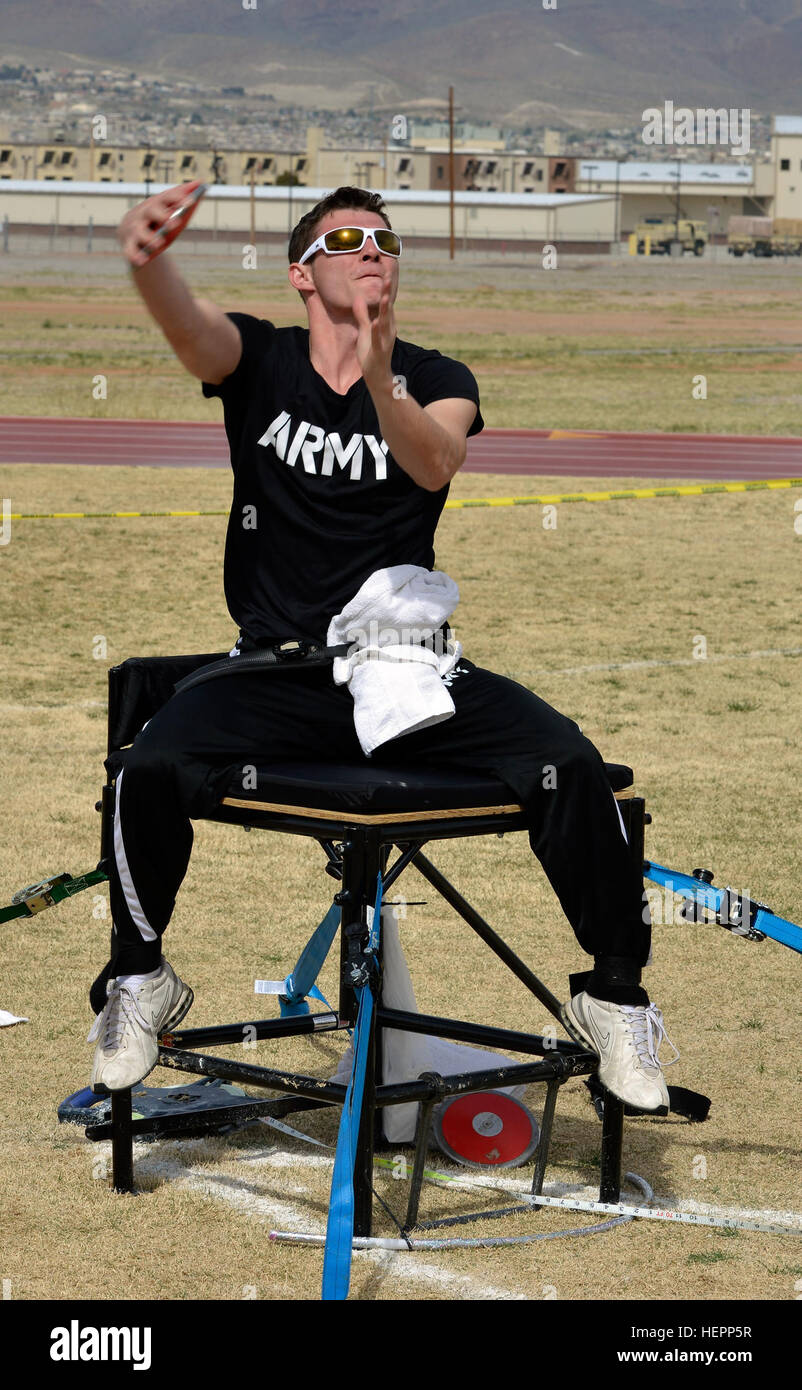 A U.S. Army Soldier throws a discus during the 2016 Army Trials seated ...