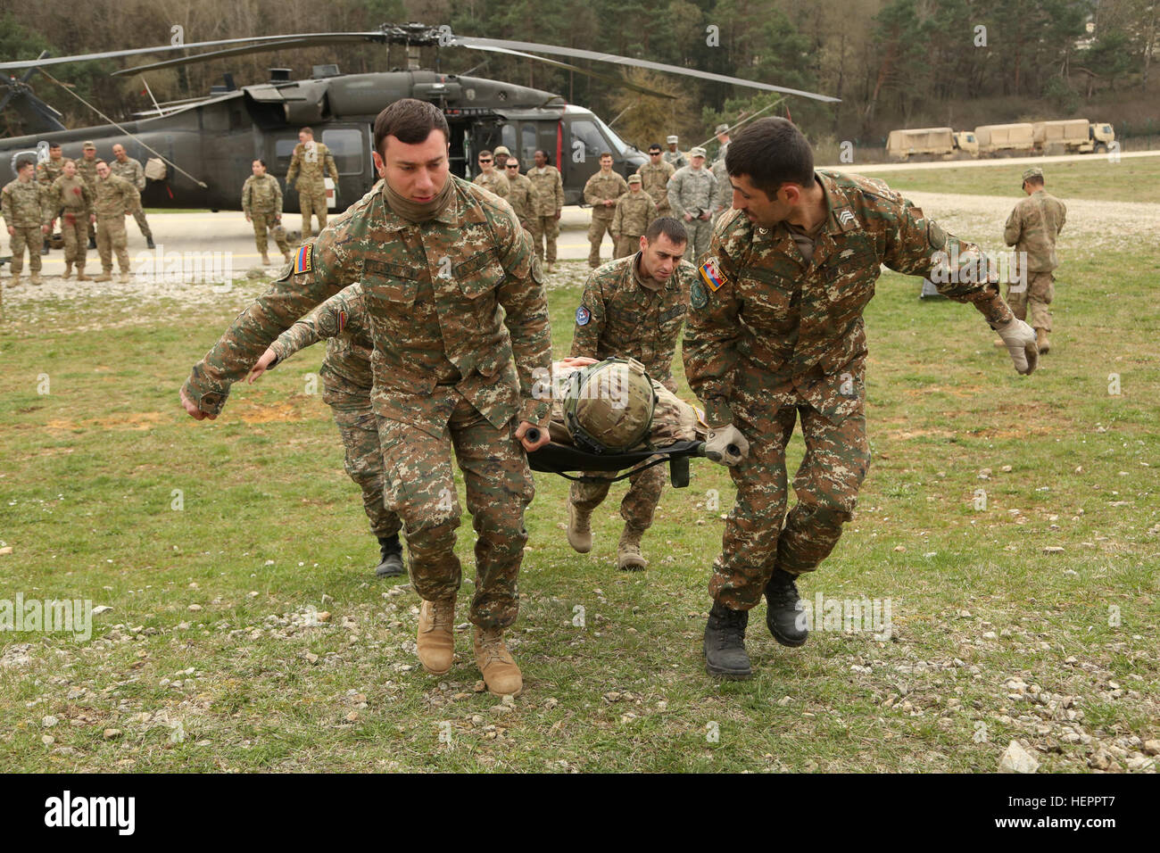 Armenian soldiers carry a simulated wounded soldier while conducting medical evacuation training during exercise Saber Junction 16 at the U.S. Army’s Joint Multinational Readiness Center (JMRC) in Hohenfels, Germany, April 9, 2016. Saber Junction 16 is the U.S. Army Europe’s 173rd Airborne Brigade’s combat training center certification exercise, taking place at the JMRC in Hohenfels, Germany, Mar. 31-Apr. 24, 2016.  The exercise is designed to evaluate the readiness of the Army’s Europe-based combat brigades to conduct unified land operations and promote interoperability in a joint, multinatio Stock Photo
