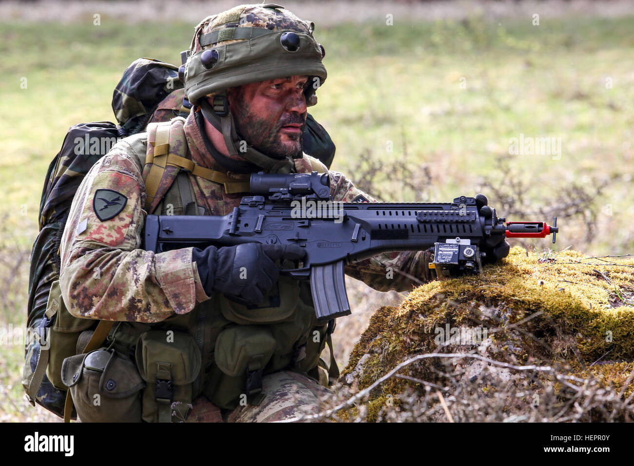 An Italian soldier of 5th Regiment, 187th Parachute Regiment “Folgore” provides security during a movement to contact scenario during exercise Saber Junction 16 at the U.S. Army’s Joint Multinational Readiness Center (JMRC) in Hohenfels, Germany, April 13, 2016. Saber Junction 16 is the U.S. Army Europe’s 173rd Airborne Brigade’s combat training center certification exercise, taking place at the JMRC in Hohenfels, Germany, Mar. 31-Apr. 24, 2016.  The exercise is designed to evaluate the readiness of the Army’s Europe-based combat brigades to conduct unified land operations and promote interope Stock Photo