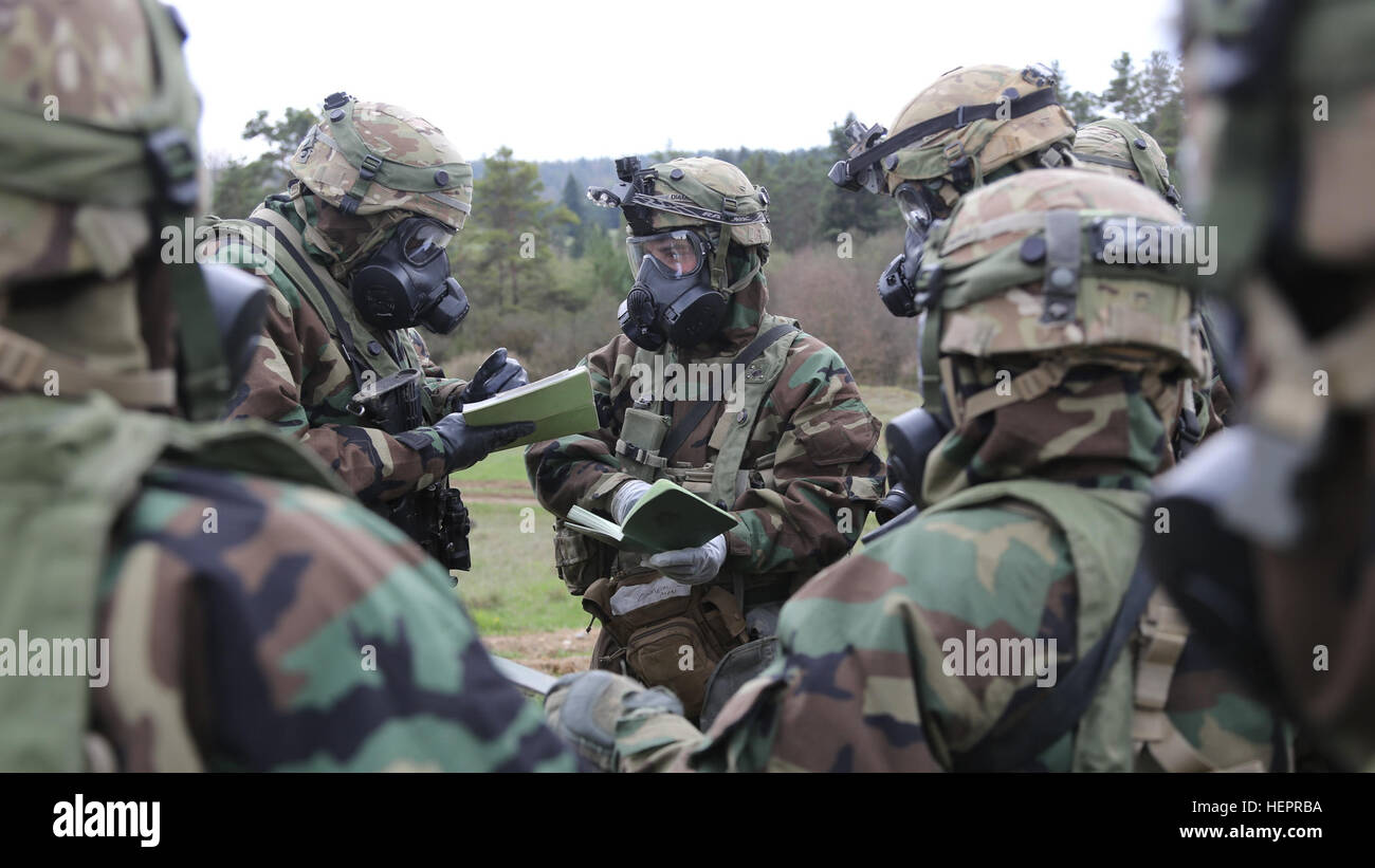 U.S. Soldiers from Headquarters and Headquarters Company, 55th Brigade Engineer Battalion, 173rd Airborne Brigade discuss operation procedures prior to gather simulated contamination samples during exercise Saber Junction 16 at the U.S. Army’s Joint Multinational Readiness Center (JMRC) in Hohenfels, Germany, April 19, 2016. Saber Junction 16 is the U.S. Army Europe’s 173rd Airborne Brigade’s combat training center certification exercise, taking place at the JMRC in Hohenfels, Germany, Mar. 31-Apr. 24, 2016.  The exercise is designed to evaluate the readiness of the Army’s Europe-based combat  Stock Photo