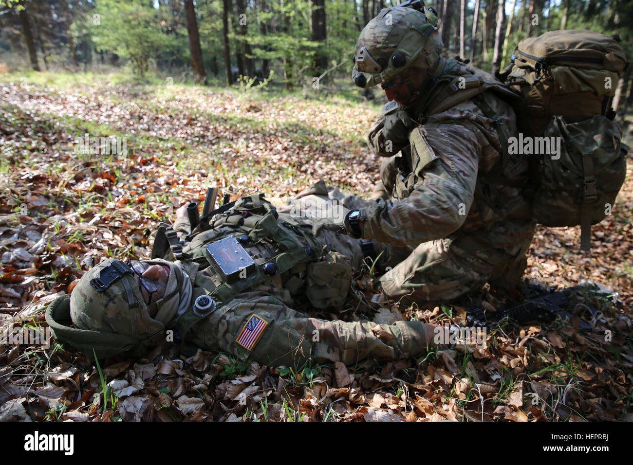U.S. Army Sgt. Felipe Ornelas, right, of 1st Battalion, 503rd Airborne Infantry Regiment, 173rd Airborne Brigade performs medical assistance on a simulated casualty while conducting defense operations during exercise Saber Junction 16 at the U.S. Army’s Joint Multinational Readiness Center (JMRC) in Hohenfels, Germany, April 19, 2016. Saber Junction 16 is the U.S. Army Europe’s 173rd Airborne Brigade’s combat training center certification exercise, taking place at the JMRC in Hohenfels, Germany, Mar. 31-Apr. 24, 2016.  The exercise is designed to evaluate the readiness of the Army’s Europe-bas Stock Photo