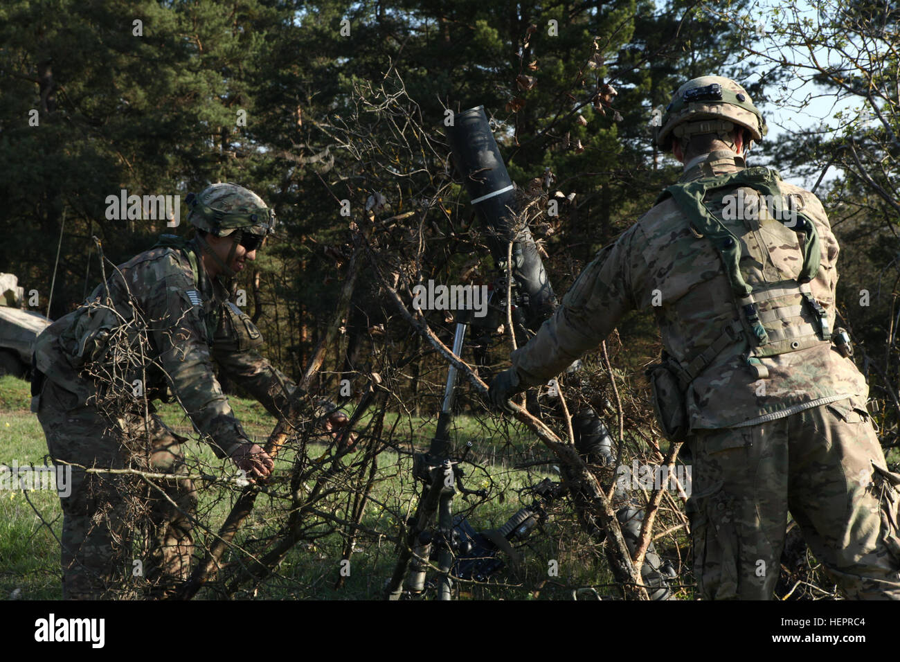 U.S. Soldiers of 1st Squadron, 91st Cavalry Regiment, 173rd Airborne Brigade camouflage a M120 mortar system while conducting defensive operations during exercise Saber Junction 16 at the U.S. Army’s Joint Multinational Readiness Center (JMRC) in Hohenfels, Germany, April 19, 2016. Saber Junction 16 is the U.S. Army Europe’s 173rd Airborne Brigade’s combat training center certification exercise, taking place at the JMRC in Hohenfels, Germany, Mar. 31-Apr. 24, 2016.  The exercise is designed to evaluate the readiness of the Army’s Europe-based combat brigades to conduct unified land operations  Stock Photo
