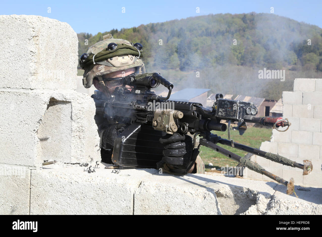 A U.S. Soldier of 1st Battalion, 503rd Infantry Regiment, 173rd Airborne Brigade returns small arms fire while clearing a town during exercise Saber Junction 16 at the U.S. Army’s Joint Multinational Readiness Center (JMRC) in Hohenfels, Germany, April 20, 2016. Saber Junction 16 is the U.S. Army Europe’s 173rd Airborne Brigade’s combat training center certification exercise, taking place at the JMRC in Hohenfels, Germany, Mar. 31-Apr. 24, 2016.  The exercise is designed to evaluate the readiness of the Army’s Europe-based combat brigades to conduct unified land operations and promote interope Stock Photo