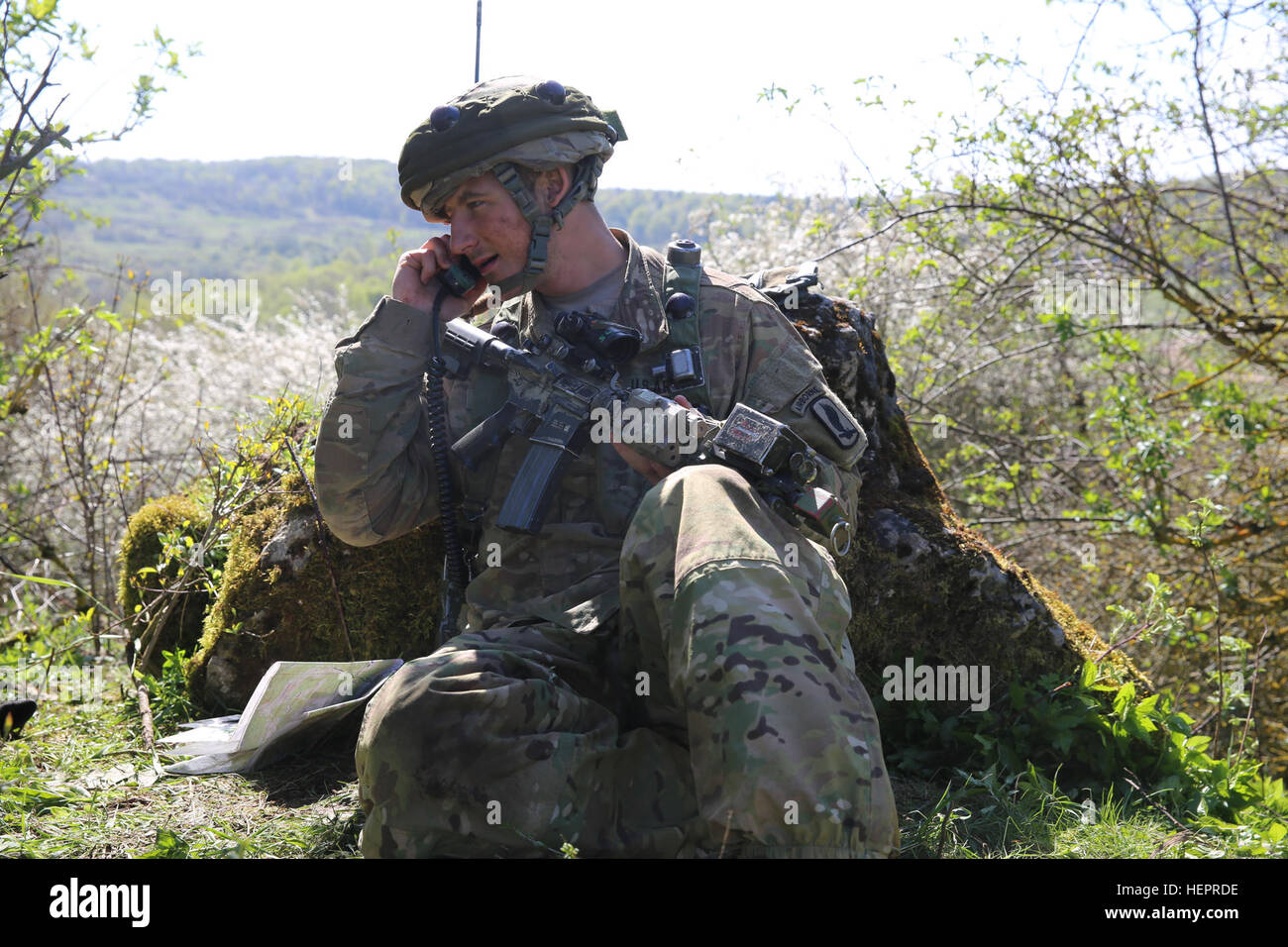 U.S. Army Spc. Daniel Fethiere of 1st Squadron, 91st Cavalry Regiment, 173rd Airborne Brigade transmits a situational report while conducting a reconnaissance training mission during exercise Saber Junction 16 at the U.S. Army’s Joint Multinational Readiness Center (JMRC) in Hohenfels, Germany, April 20, 2016. Saber Junction 16 is the U.S. Army Europe’s 173rd Airborne Brigade’s combat training center certification exercise, taking place at the JMRC in Hohenfels, Germany, Mar. 31-Apr. 24, 2016.  The exercise is designed to evaluate the readiness of the Army’s Europe-based combat brigades to con Stock Photo